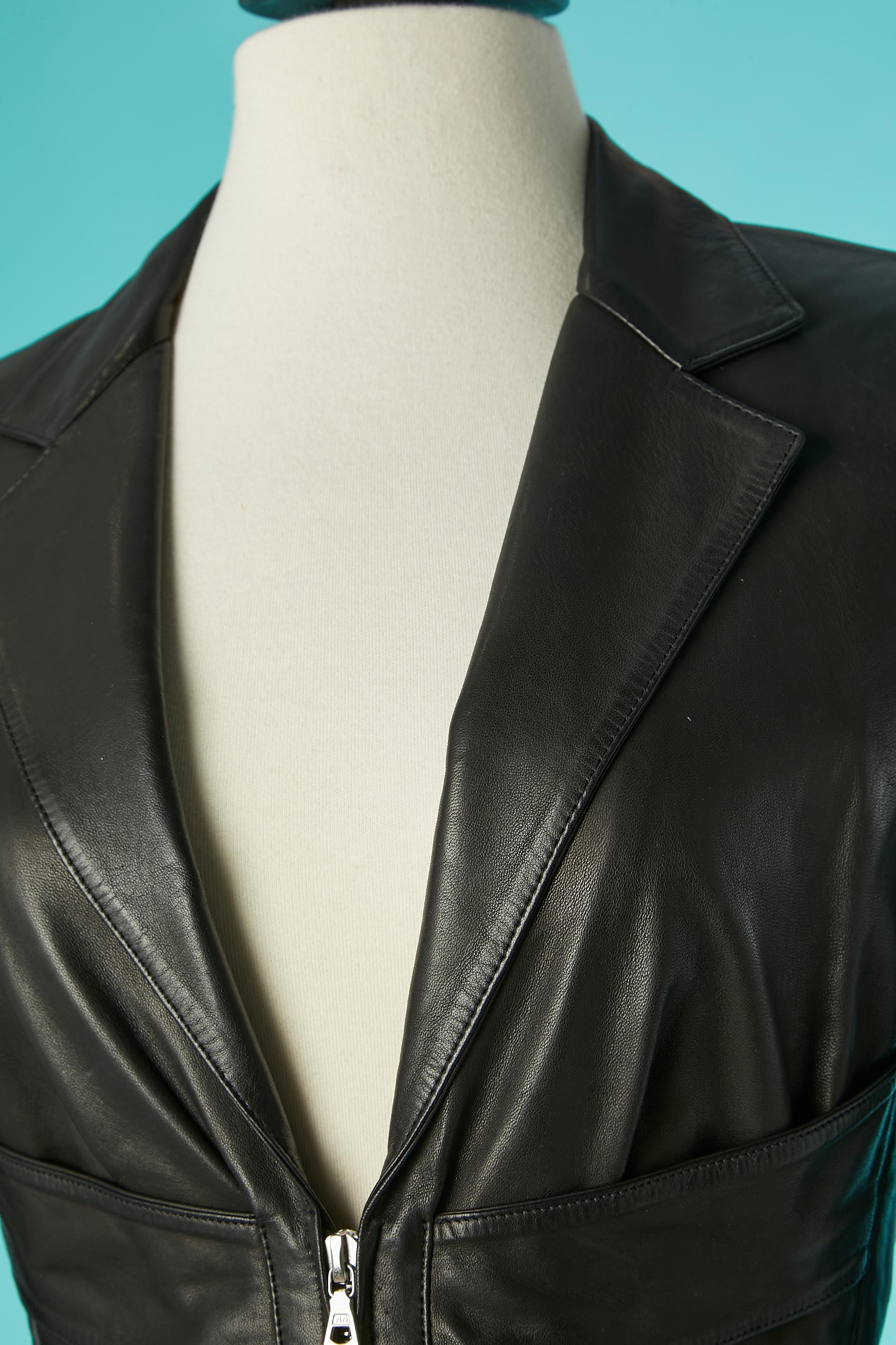 Black leather jacket with cut-work and laces in the back. Shell : sheep leather. Lining composition: 70% acetate, 30% rayon. 
Shoulder pad. Buttons and buttonholes on the cuffs. 
SIZE M 