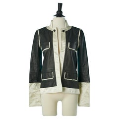 Black leather jacket with ivory satin edge and branded decorative button Chanel 