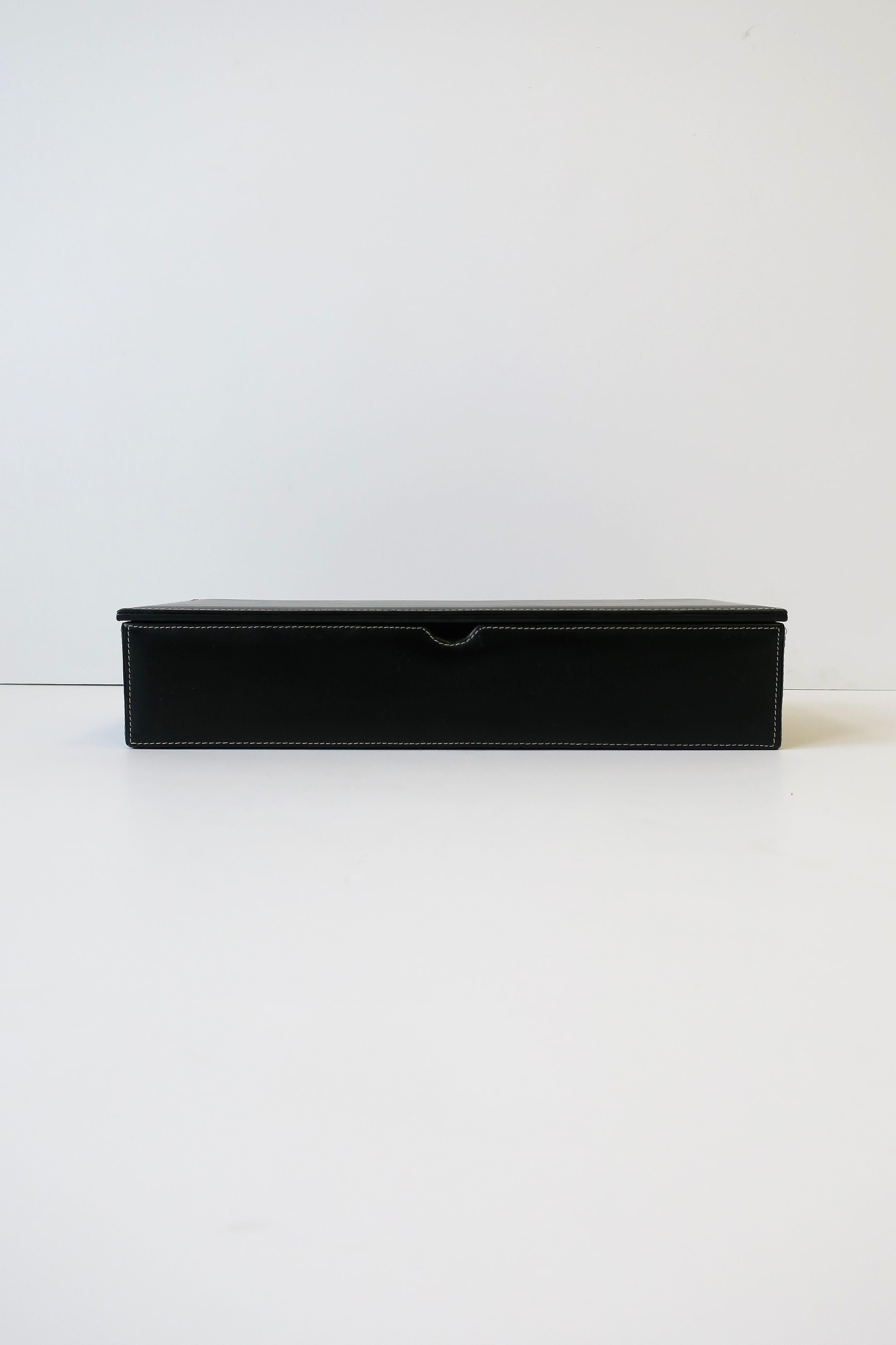 A black leather jewelry or desk box with black velvet lined interior. Leather box is rectangular in shape and has four internal comportments. Great for jewelry, small item, as a desk or vanity box, etc. 

Box measures: 2.75