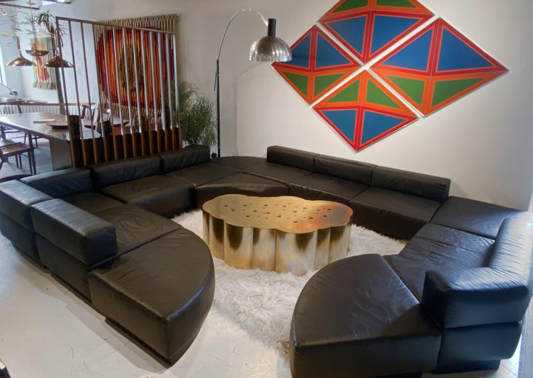Thirteen-section black leather 'Cubo' sofa designed by Harvey Probber. The Cubo sectional is comprised of five sections with attached back cushions, one corner section with attached back cushions, one angular section with attached back cushion, one