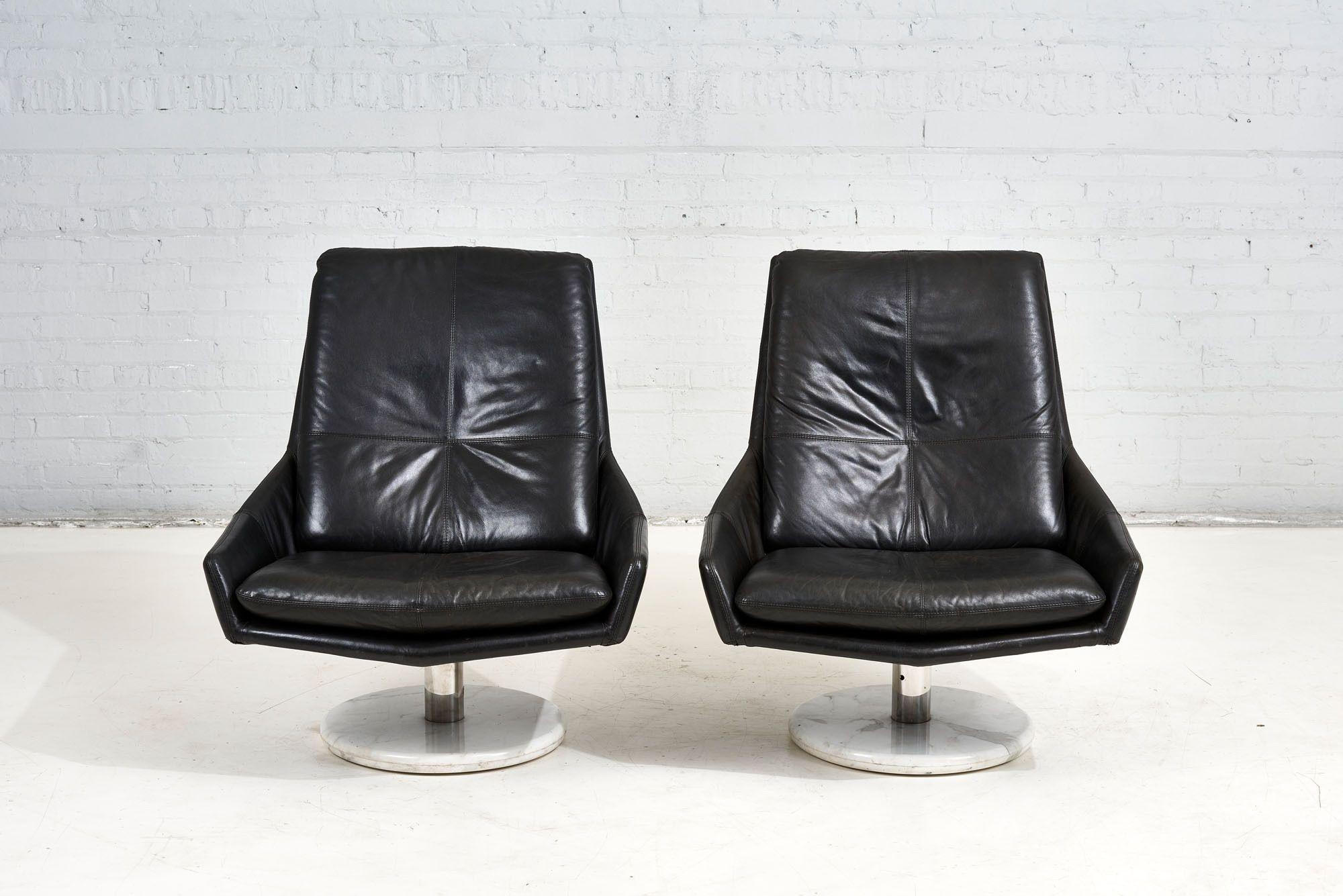 Pair black leather lounge chairs on stainless steel and Calacutta marble bases, circa 1970’s. Very good original condition.

