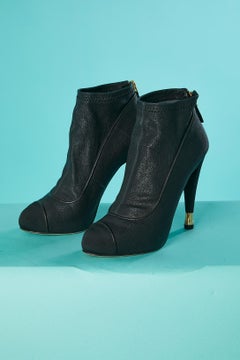 Black leather low boots with inside platform and metalic details on heel Chanel