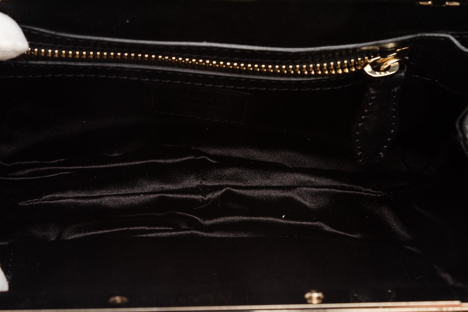 Black leather MCM clutch with gold-tone hardware and small crystal 1