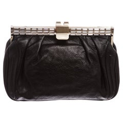 Black leather MCM clutch with gold-tone hardware and small crystal