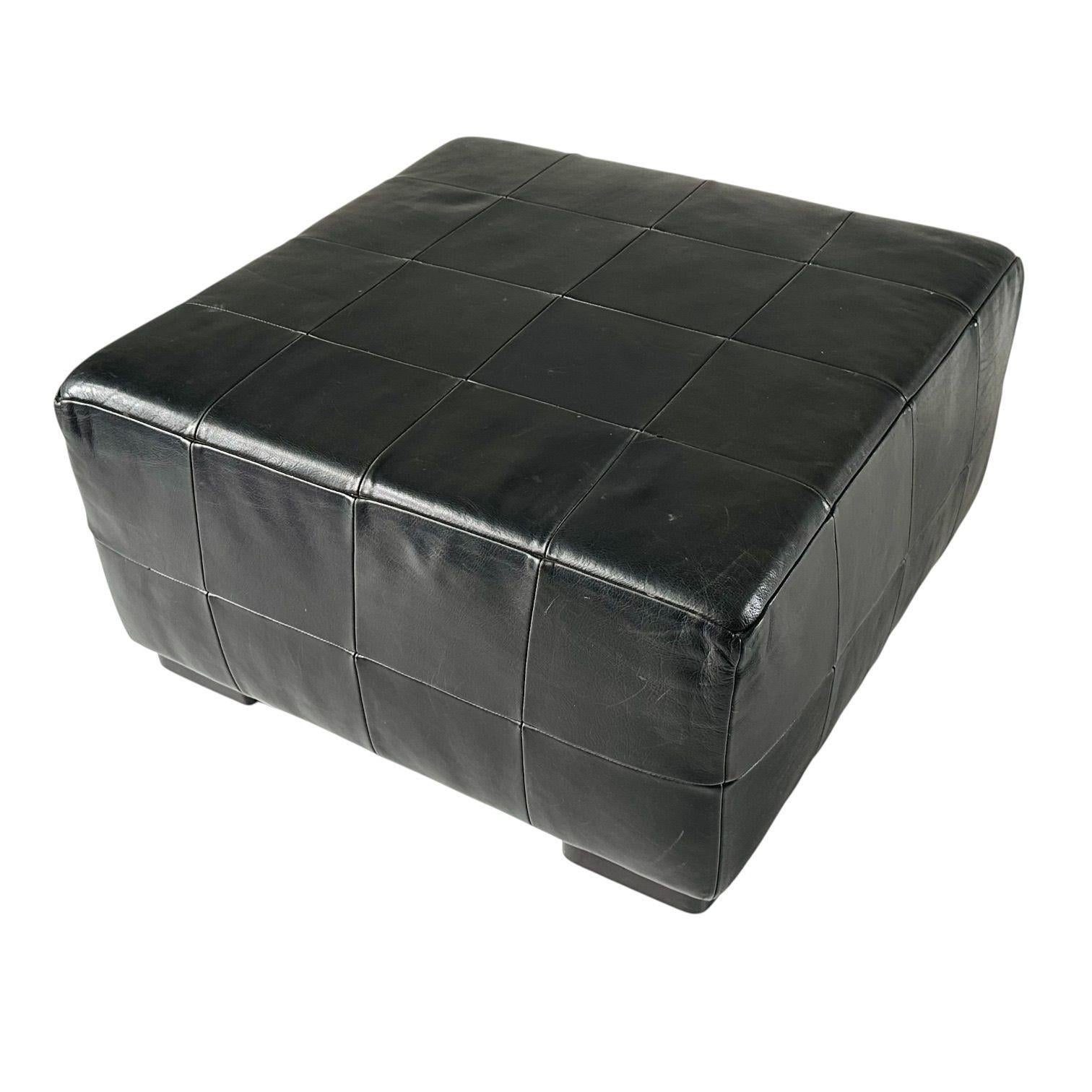 Black Leather Patchwork Ottoman, 1980’s.  Original with natural patina
Measures 16.5” tall 30.5” x 30.5”