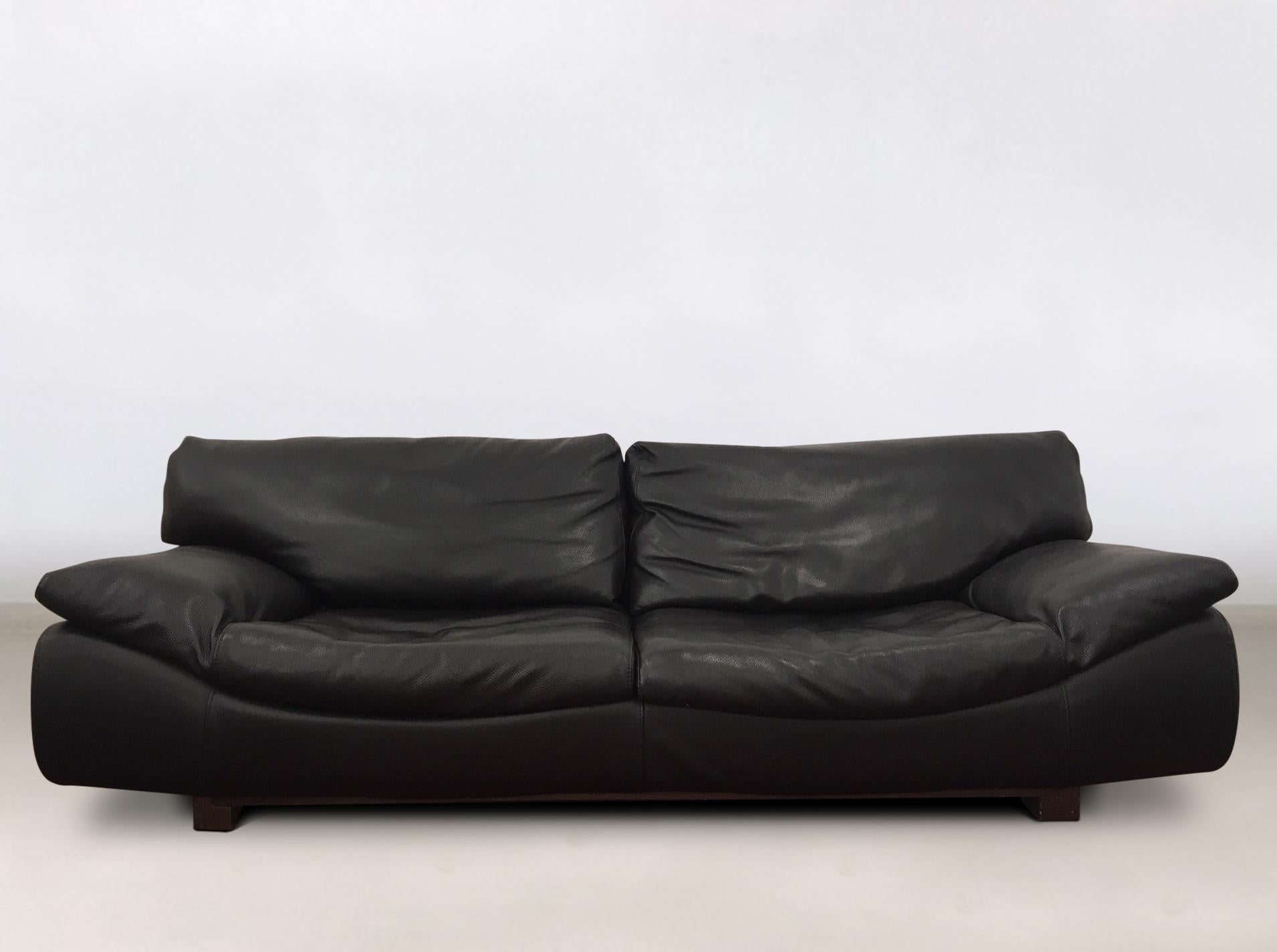 Gorgeous ensemble, consisting of a large sofa and two lounge chairs. All pieces feature a
thick black leather upholstery on a wooden base. Straps and zippers to remove parts or to keep parts to their place. The set remains in wonderful condition