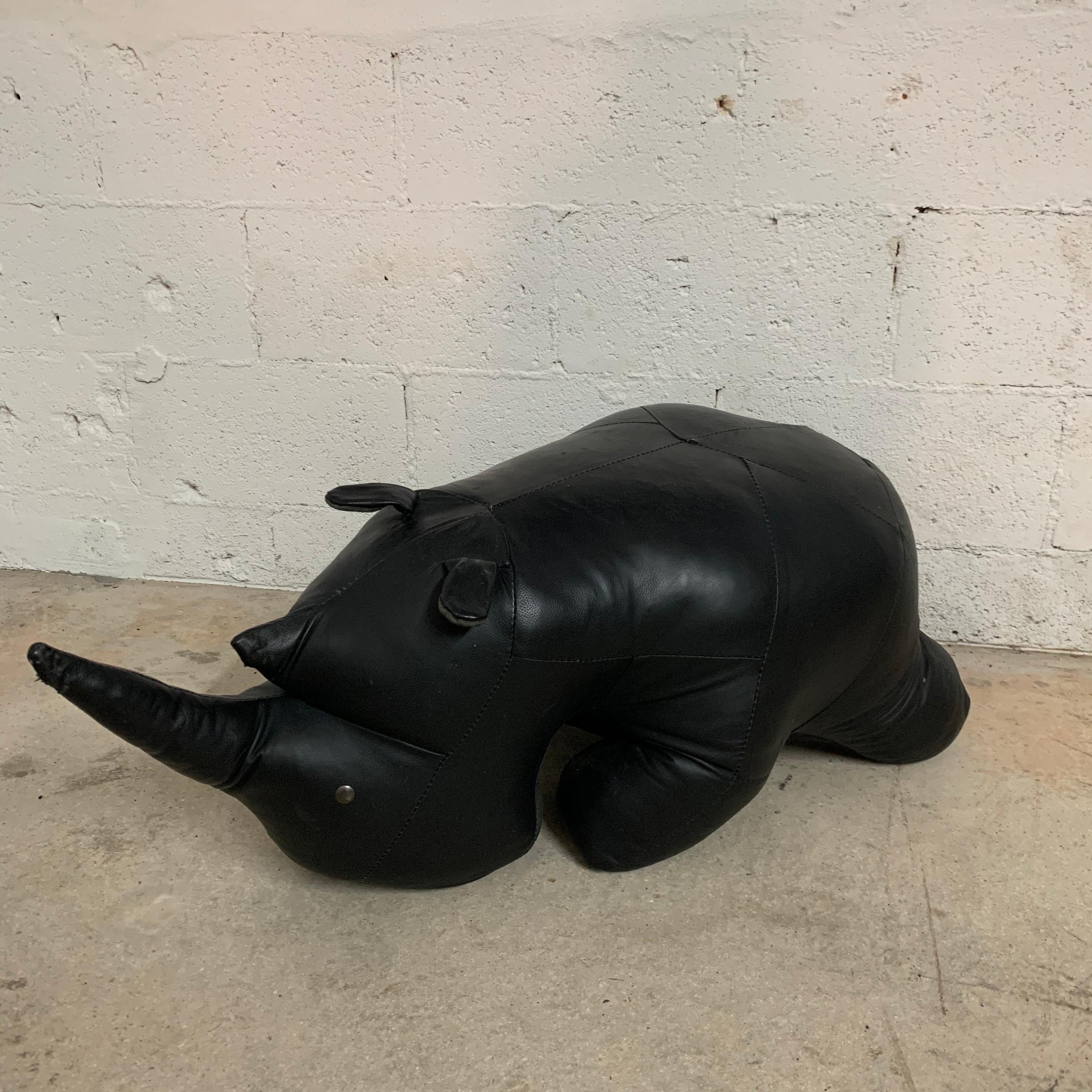 Midcentury rhino footstool or ottoman rendered in black stitched leather attributed to Dimitri Omersa for Abercrombie & Fitch.