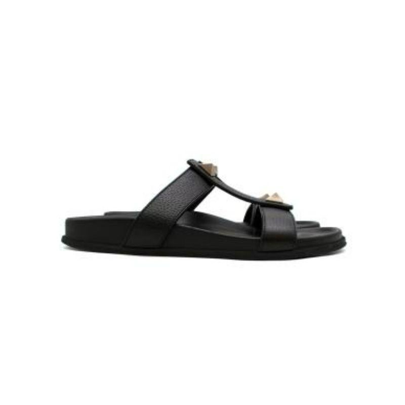 Valentino black leather Roman Stud sandals
 
 
 
 -Upper in textured leather
 
 -Round and open toe
 
 -Maxi studs applied
 
 -T-shaped structure
 
 -Branded leather insoles 
 
 -Open heel and toe 
 
 
 
 Material:
 
 
 
 Leather 
 
 
 
 Made in