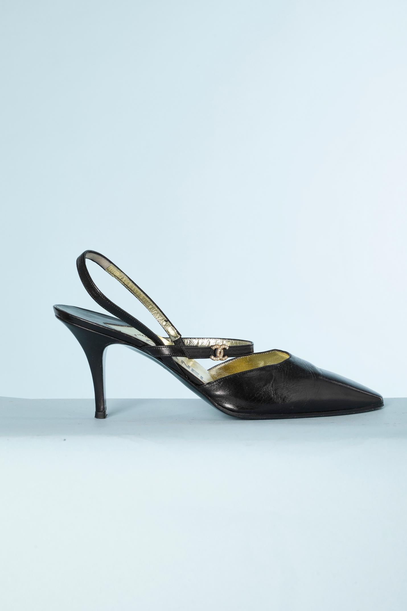Black leather sandal with double flange and gold leather lining.