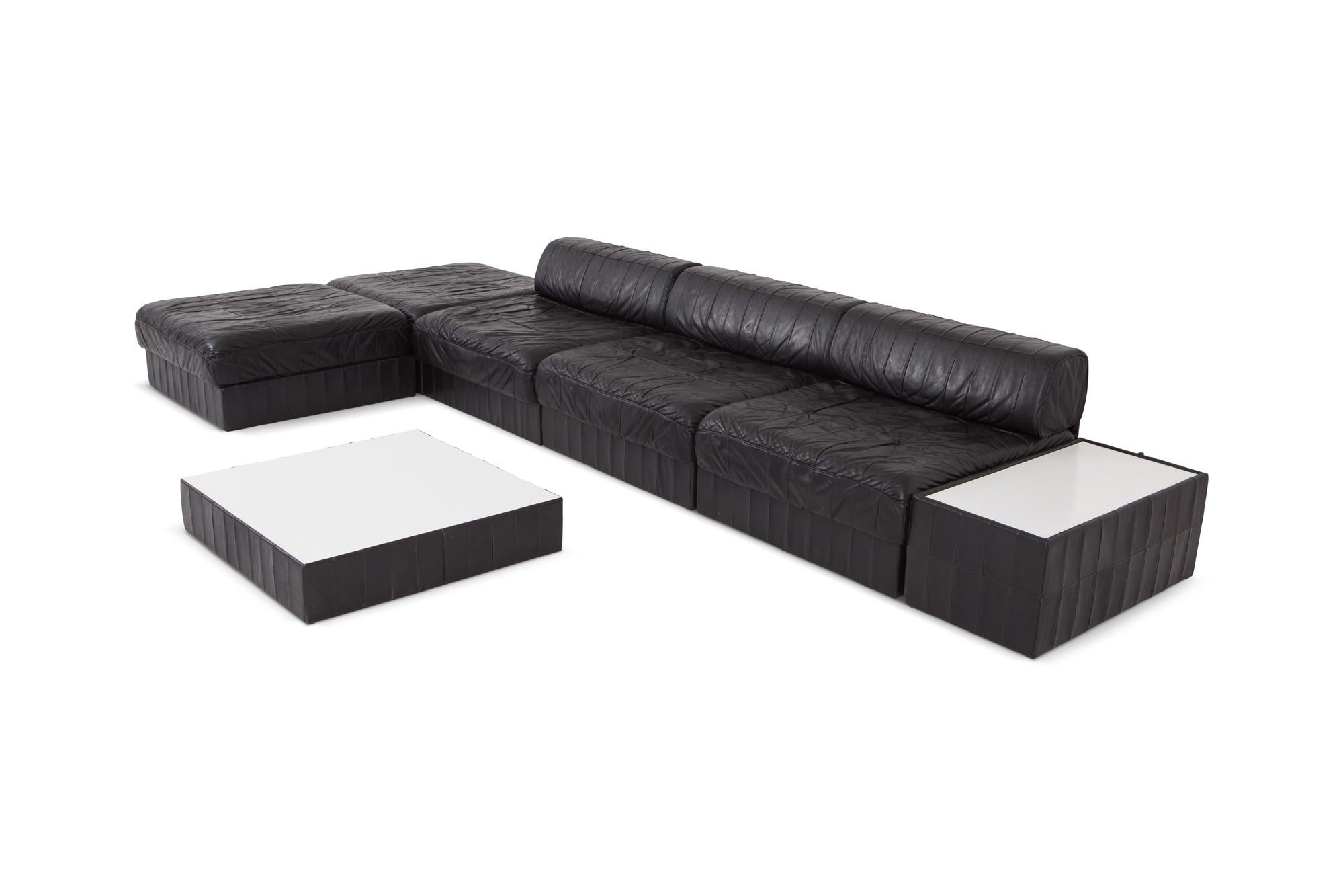 Vintage De Sede black leather patchwork sectional sofa model DS 88.
A Mid-Century Modern set designed by the renowned Swiss leading manufacturer of exclusive leather furniture. All items in this set are in very good condition.


Large set