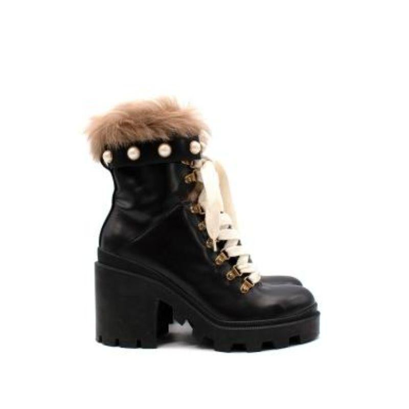 Gucci black leather shearling trimmed combat boots
 

 - Robust black leather outer
 - Ivory woven laces
 - Cleated black rubber sole and block heel
 - Shearling lined
 - Faux-pearl trim 
 

 Materials: 
 Leather
 Shearling
 

 Made in Italy 
 

