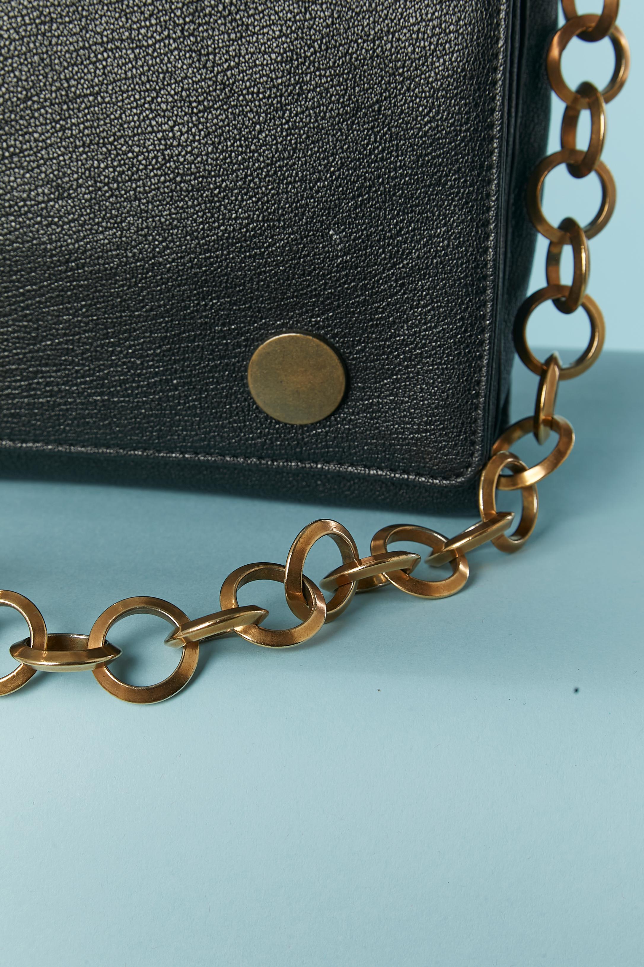 Black leather shoulder bag with gold metal chain. Black fabric ( probably rayon) lining. 3 compartiments inside. Gros-grain decorative bow. Snap closure under the top flap. 
SIZE : 25cm X 15cm X 7cm
Chain lenght's = 75cm