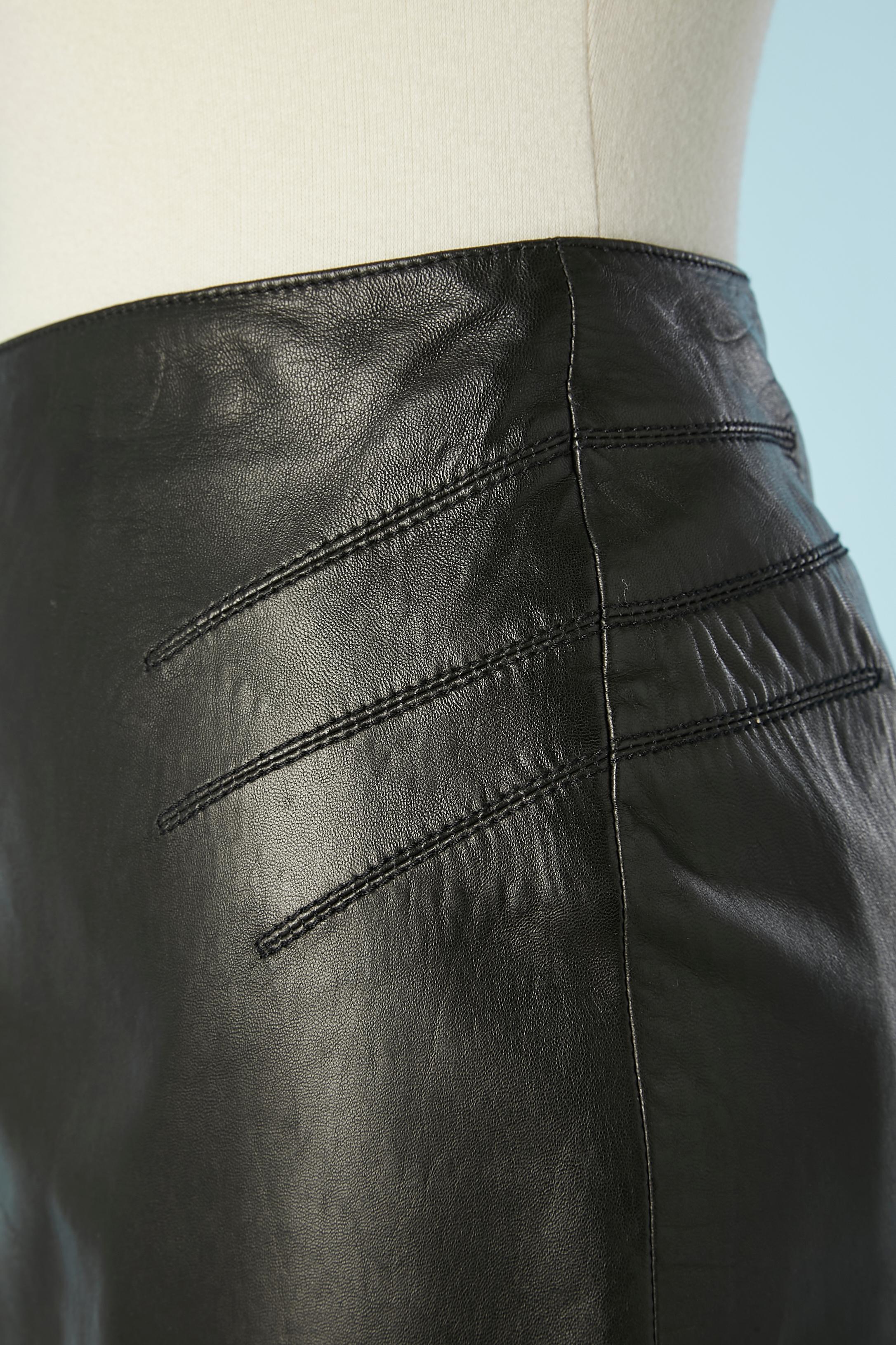 Black leather skirt with cut work on the hips and on the back. zip in the middle back. Lining composition: 57% rayon, 43% polyester. 
SIZE 14 (Us) 