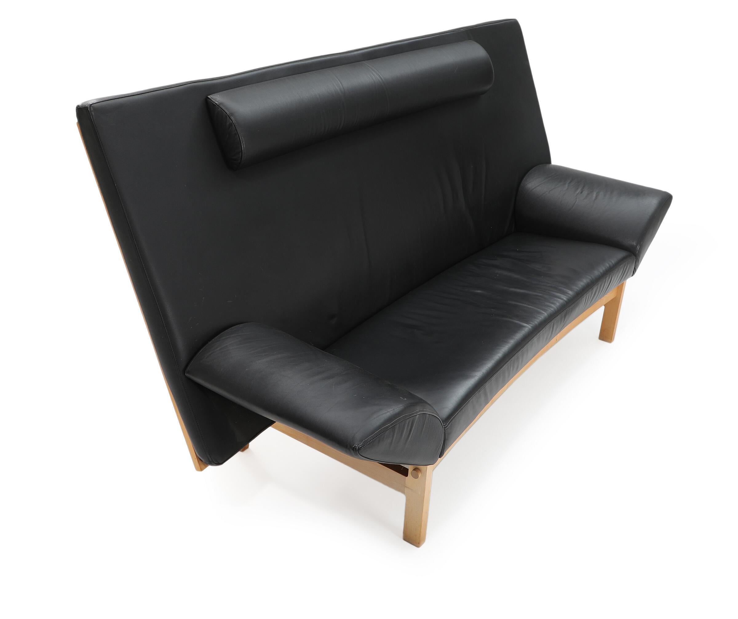 Three-seater sofa with maple frame, upholstered with black leather. Model GE 299. Manufactured and marked by Getama.