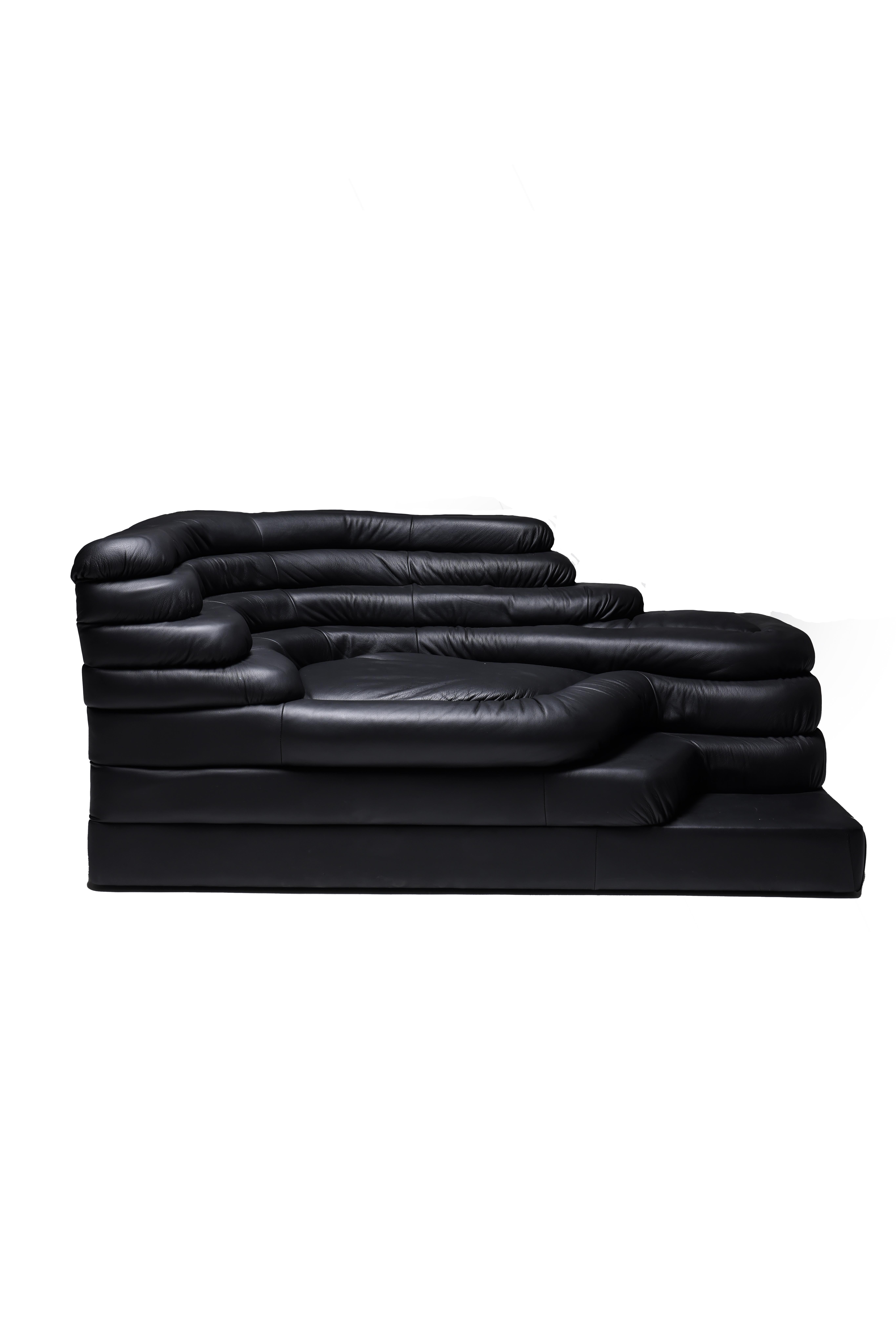 Modular sofa Terrazza 'DS-1025' in black padded leather by designer Ubald Klug (born in 1932) for the Swiss firm De Sede, 1970s. The design of this sofa was inspired by waves, waterfalls, and rock formations, clearly visible in the sofa's overlay.