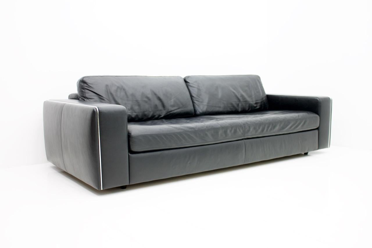 Beautiful high quality leather sofa in black soft leather and a nice polished steel frame. The cushions are with down fill. The condition is very good. It is very heavy.
 