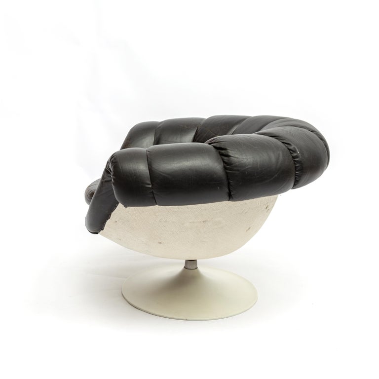Stunning swivel lounge chair in white fiberglass with aluminum base and original black leather cover. 

