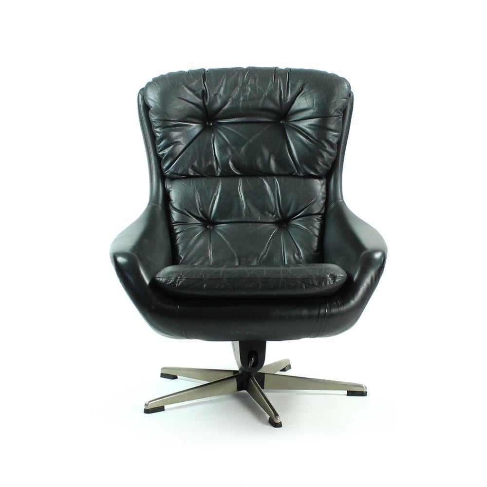 Black leather swivel armchair produced by Peem company in Finland. No design lover will overlook this beautiful item. It has amazing design with beautiful lines and curves, with a high comfort of seating, the chair is very comfortable. Original