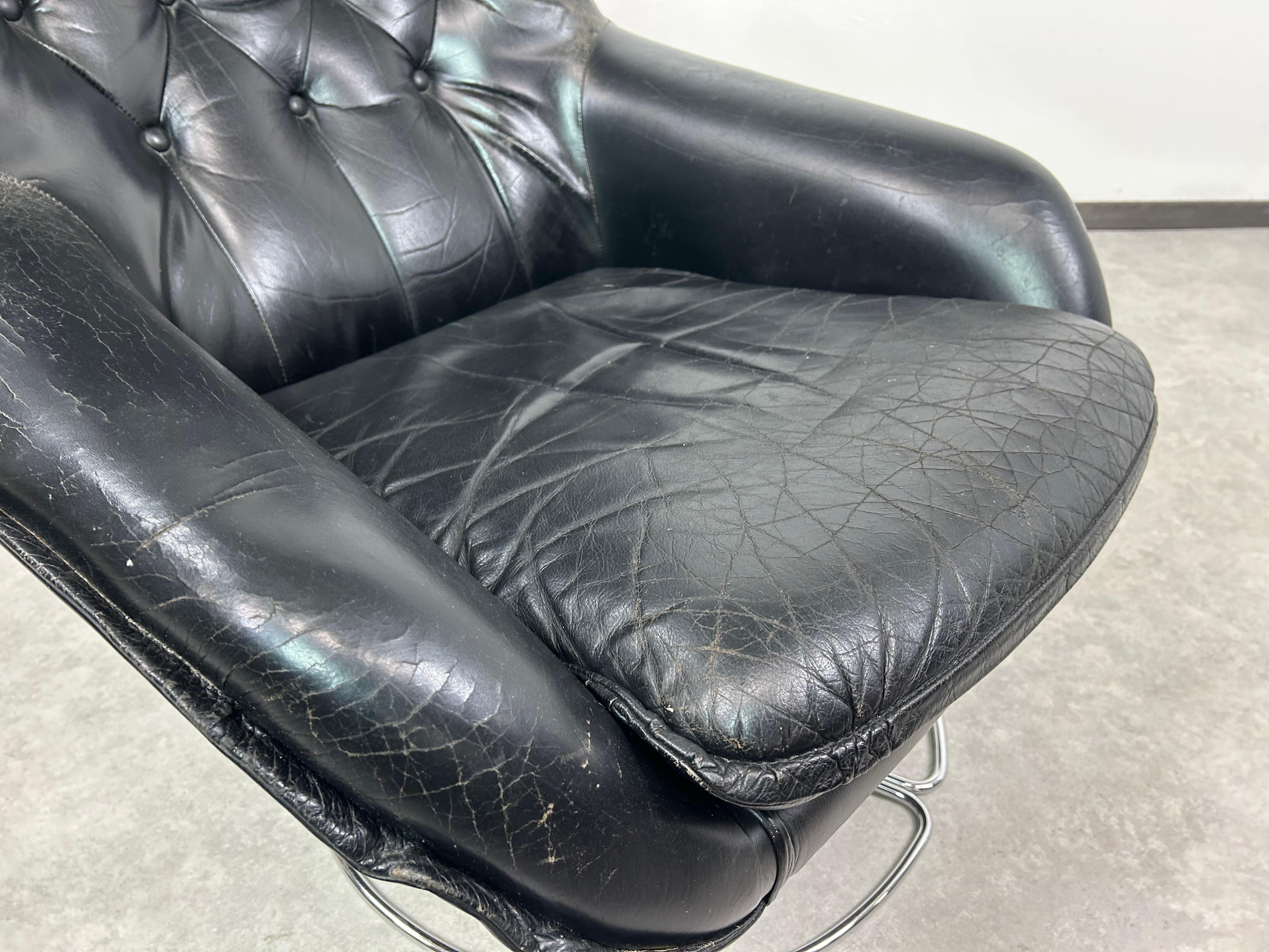 Mid-20th Century Black leather swivel wingchair by PeeM For Sale