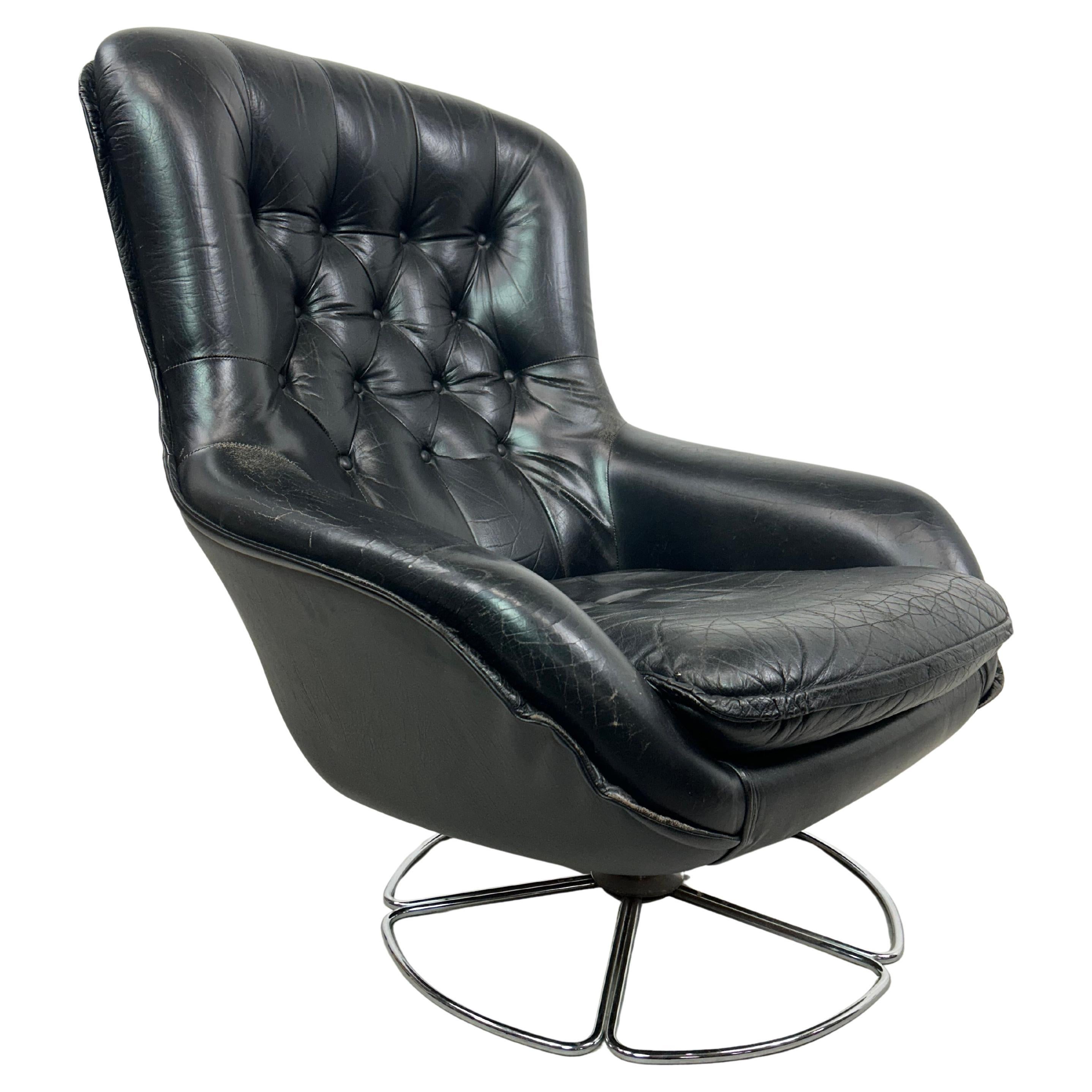 Black leather swivel wingchair by PeeM For Sale