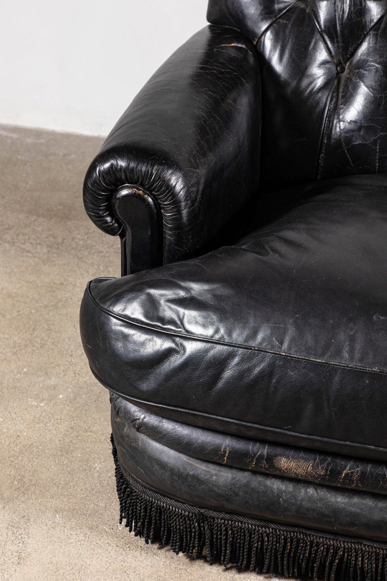 Black Leather Tufted Sofa with Tufting and a Fringed Base ...