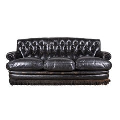 Black Leather Tufted Sofa with Tufting and a Fringed Base