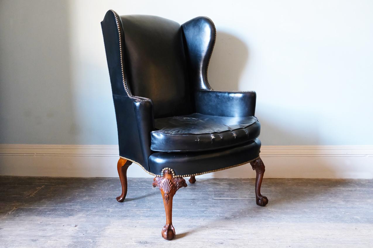 English Georgian Black Leather-Upholstered Wingback Armchair with Ball & Claw Feet For Sale