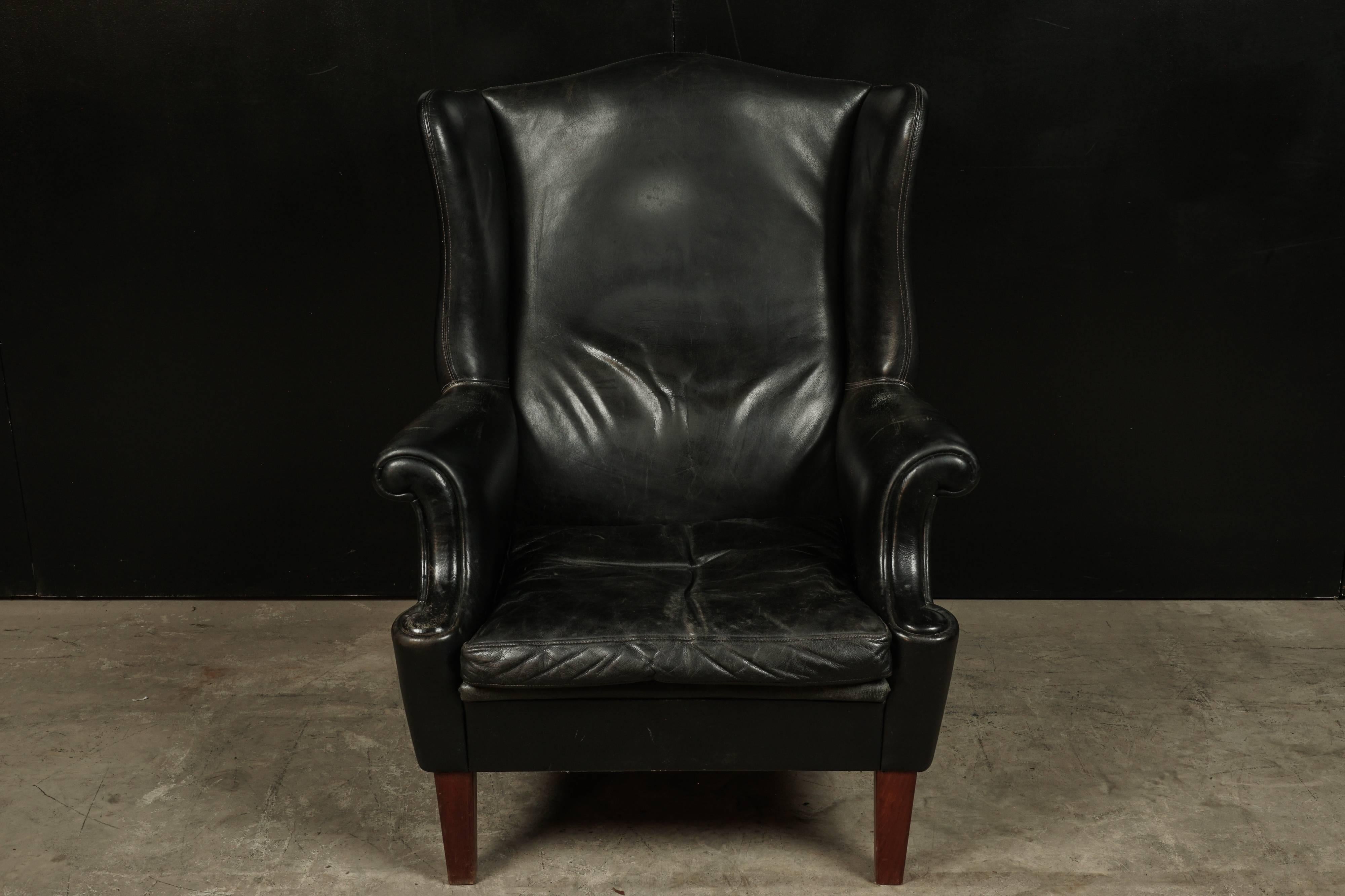Black leather wingback chair from Denmark, circa 1960. Leather with nice patina and wear.