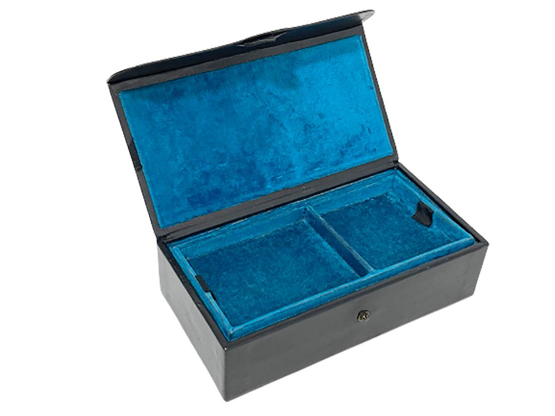 Black leather with Indonesian silver 1920s jewelry box

A jewelry box in black leather with Indonesian silver on top of the lid 
The interior is with blue (Azur blue) velvet fabric with a movable insert tray for your jewelry.
The silver handmade