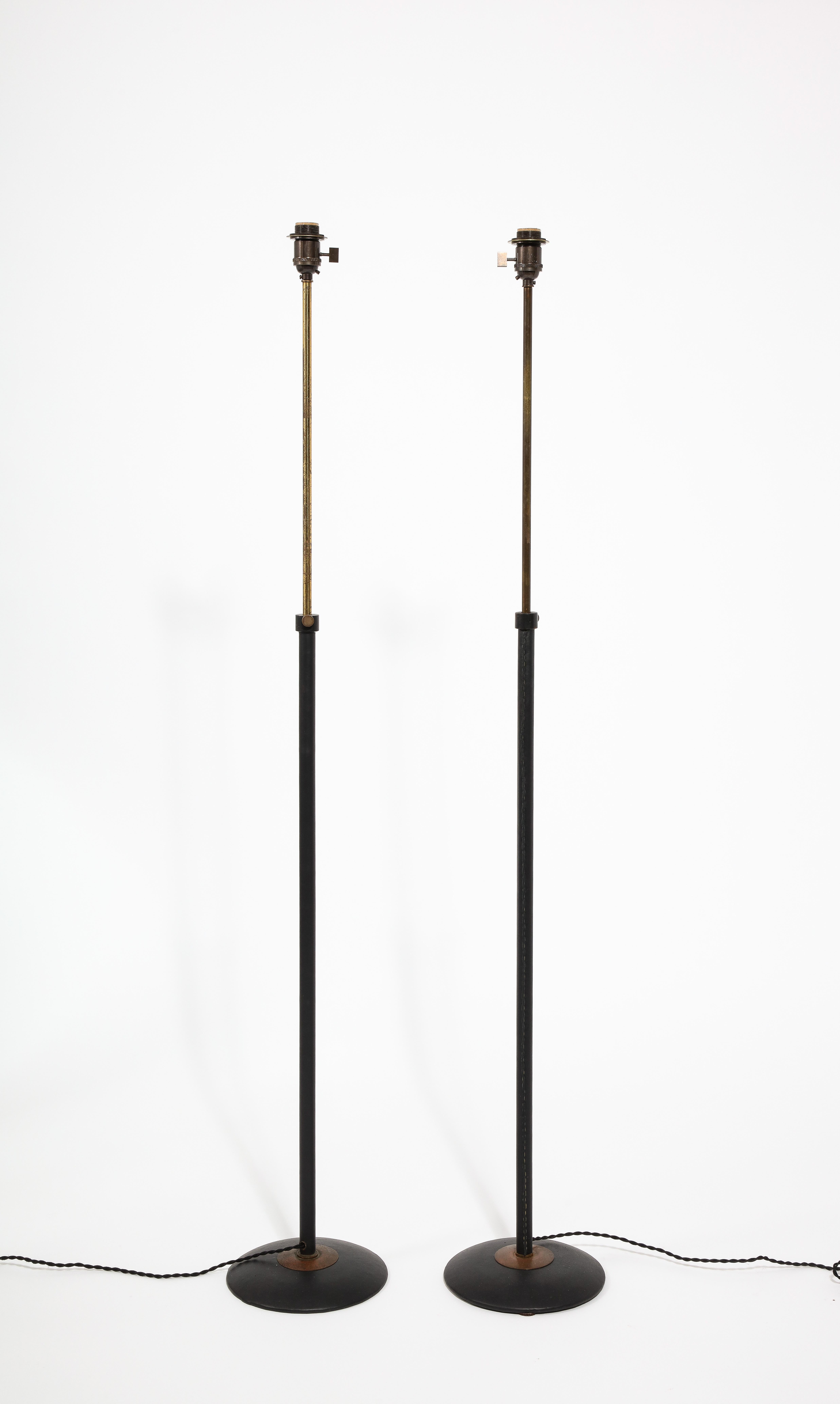 Elegant pair of telescopic floor lamps wrapped in black leather. Rewired. Shades are available on request.