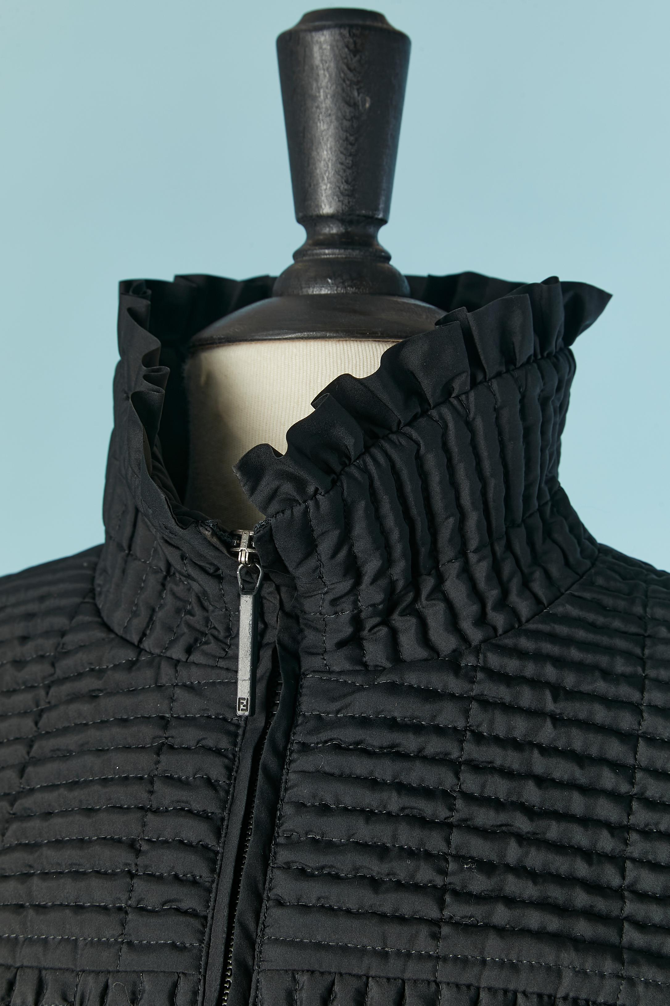 Black lightly quilted jacket with ruffles edge. Zip closure on the middle front with branded zip puller. No fabric composition tag. 
SIZE on tag : 44 (It) 40 (Fr) 10 (Us) M /L 
