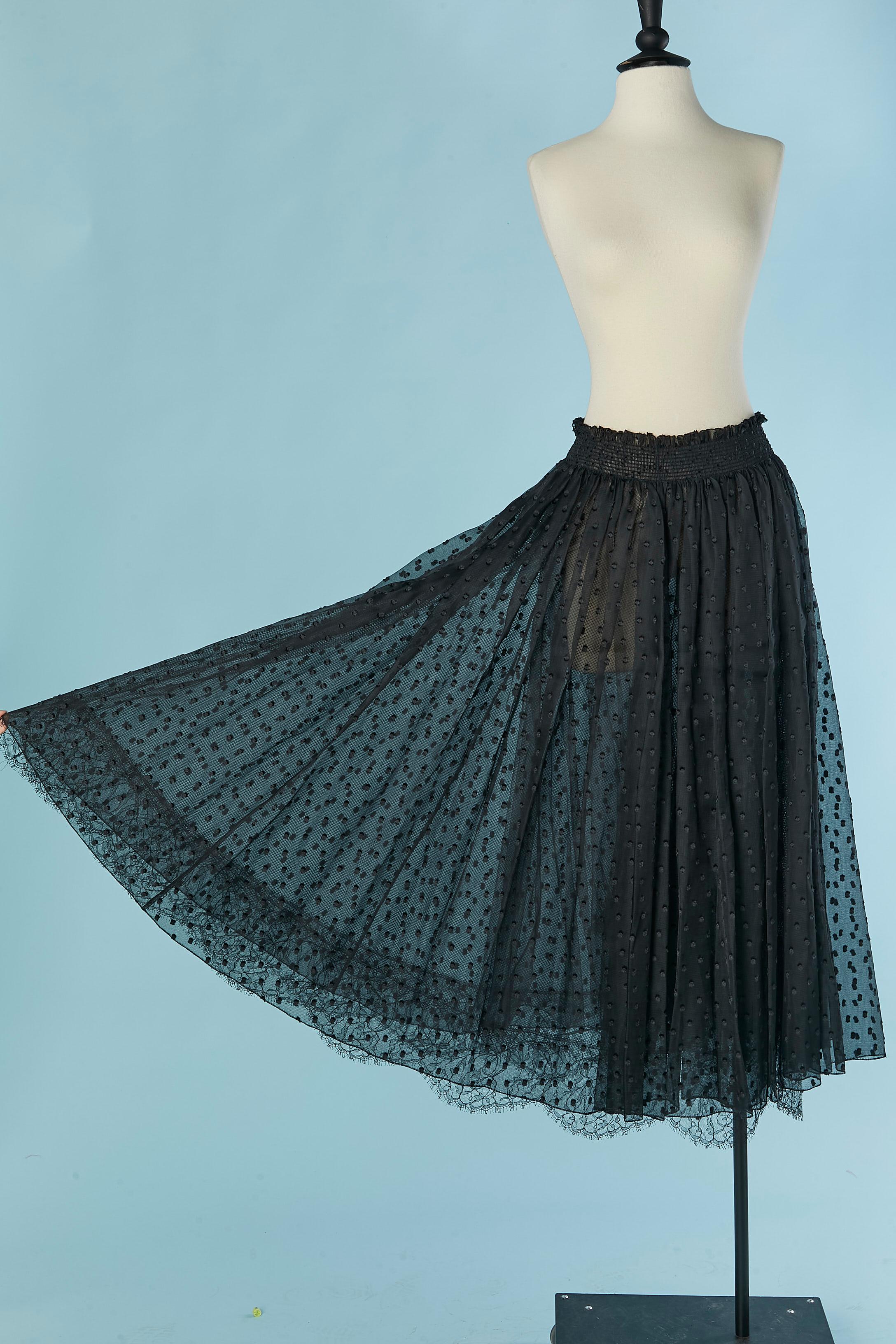 Black long skirt made of double lays of plumetis silk and tulle. Elastic waist . 
The underlay is in mesh tulle with lace edge .
SIZE 38 (Fr) M 
