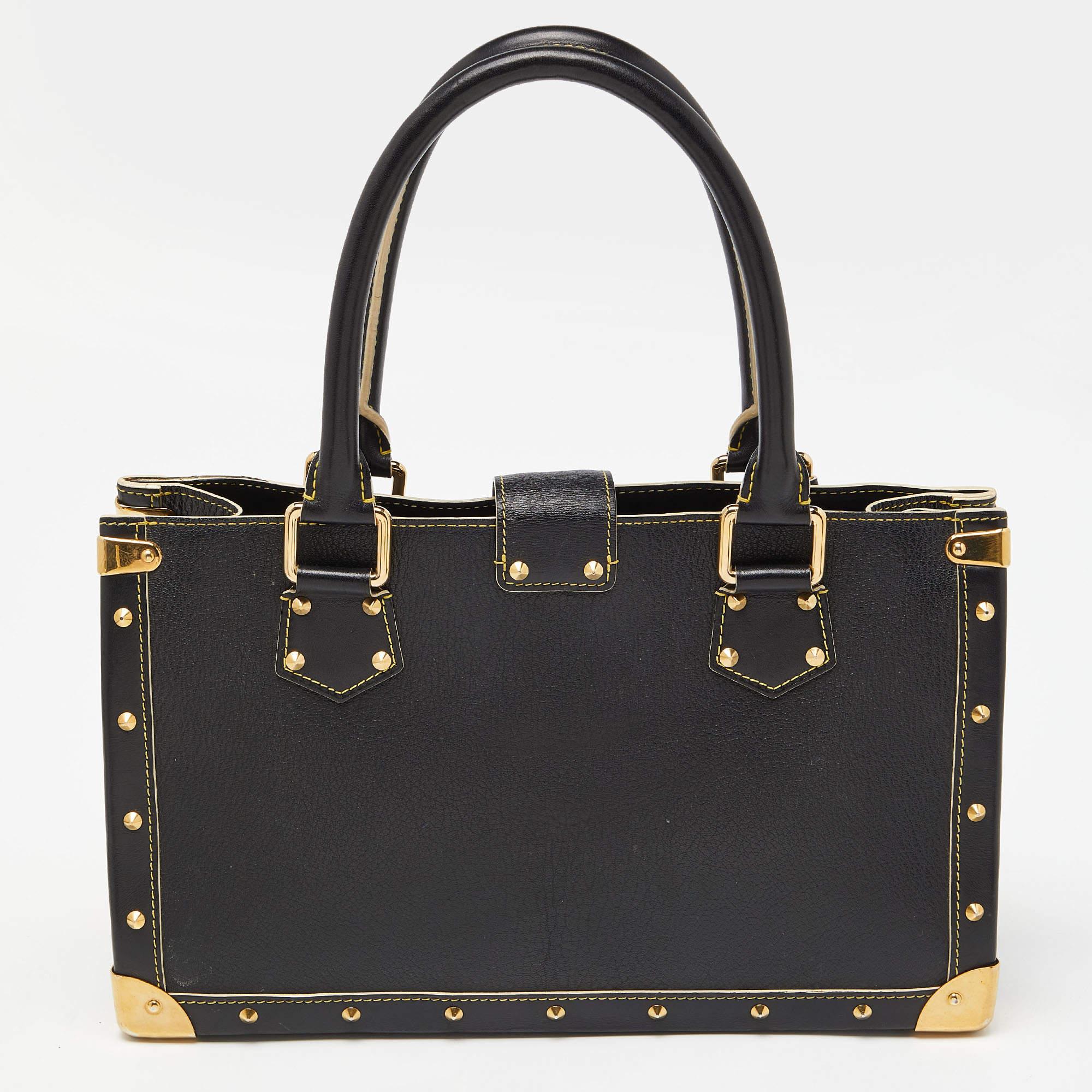 Louis Vuitton's Le Fabuleux bag looks nothing like a regular Louis Vuitton bag! Rectangular in shape, the bag is crafted from black Suhali leather and has stud embellishments. It features dual top handles, a front zip pocket, and the S lock
