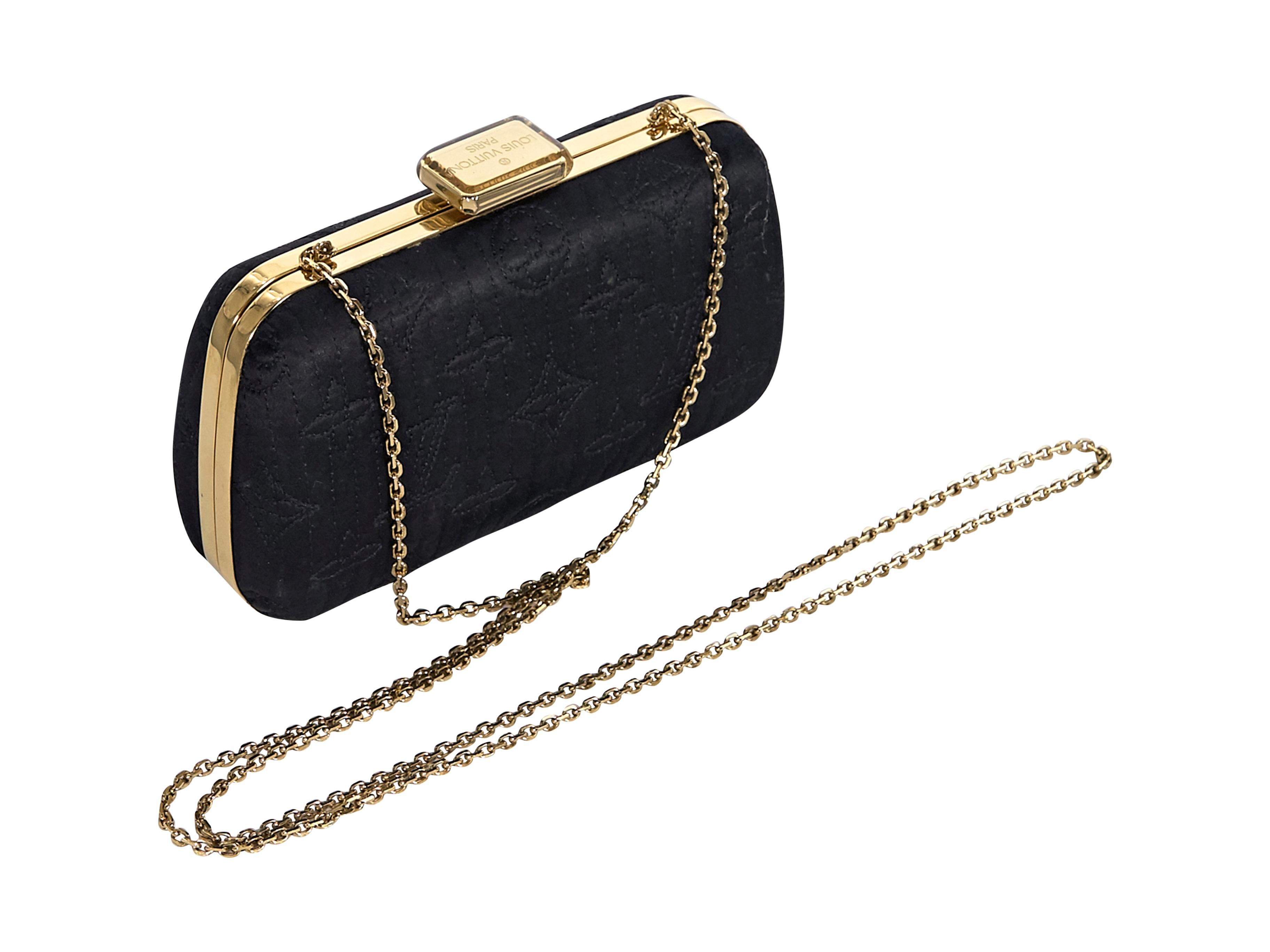 Product details:  Black monogram quilted satin clutch by Louis Vuitton.  Tuck-away shoulder strap.  Top push clasp closure.  Leather lined interior . Goldtone hardware.  6.5