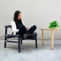 Lounge chair in black tinted wood, black leather seat