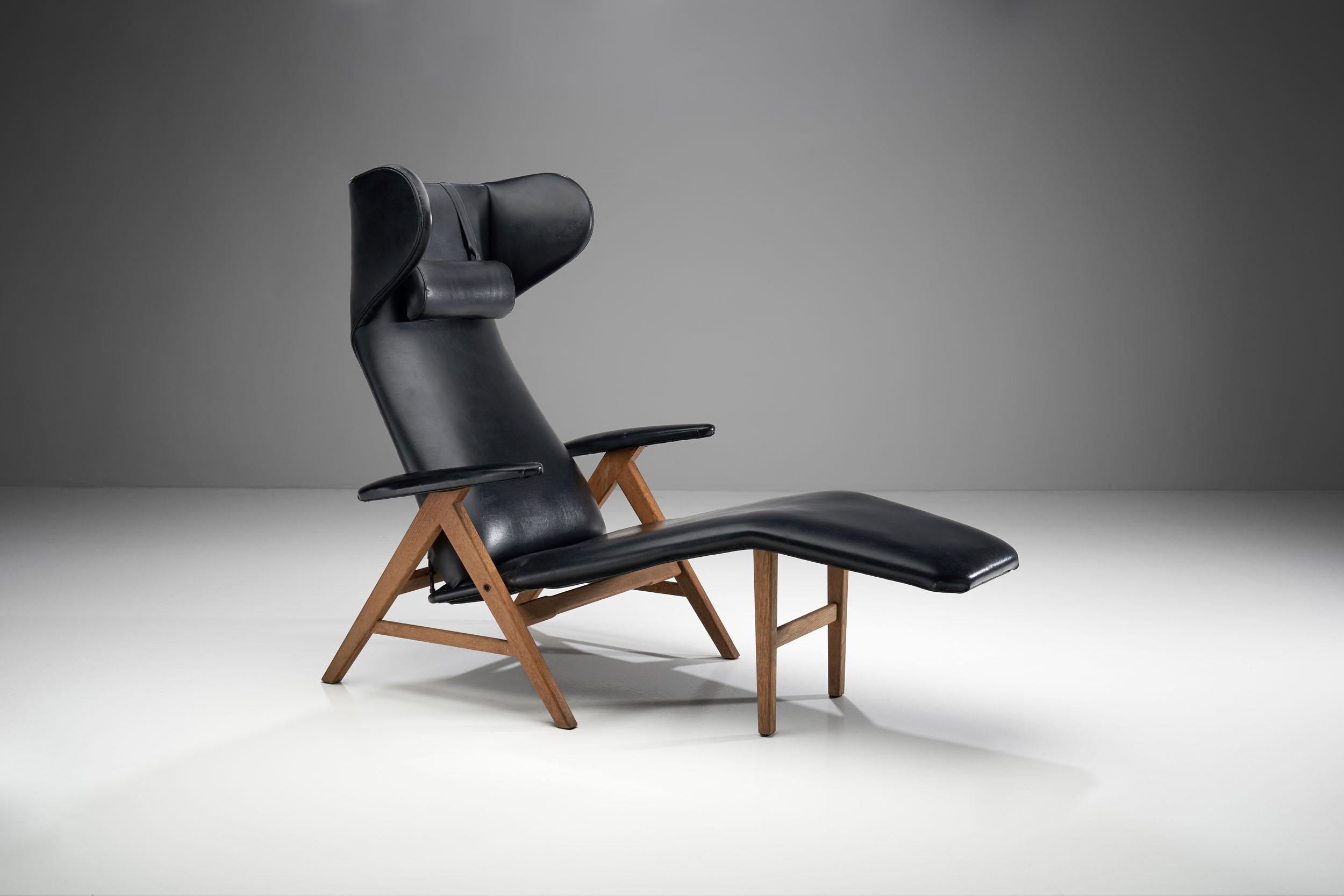 Black Chaise lounge with stained beech frame, commonly attributed to H.W. Klein for Bramin. 

This wonderfully crafted lounge chair has a tilt function, which makes it extremely comfortable. The seat is extended in soft lines as a chaise longue to
