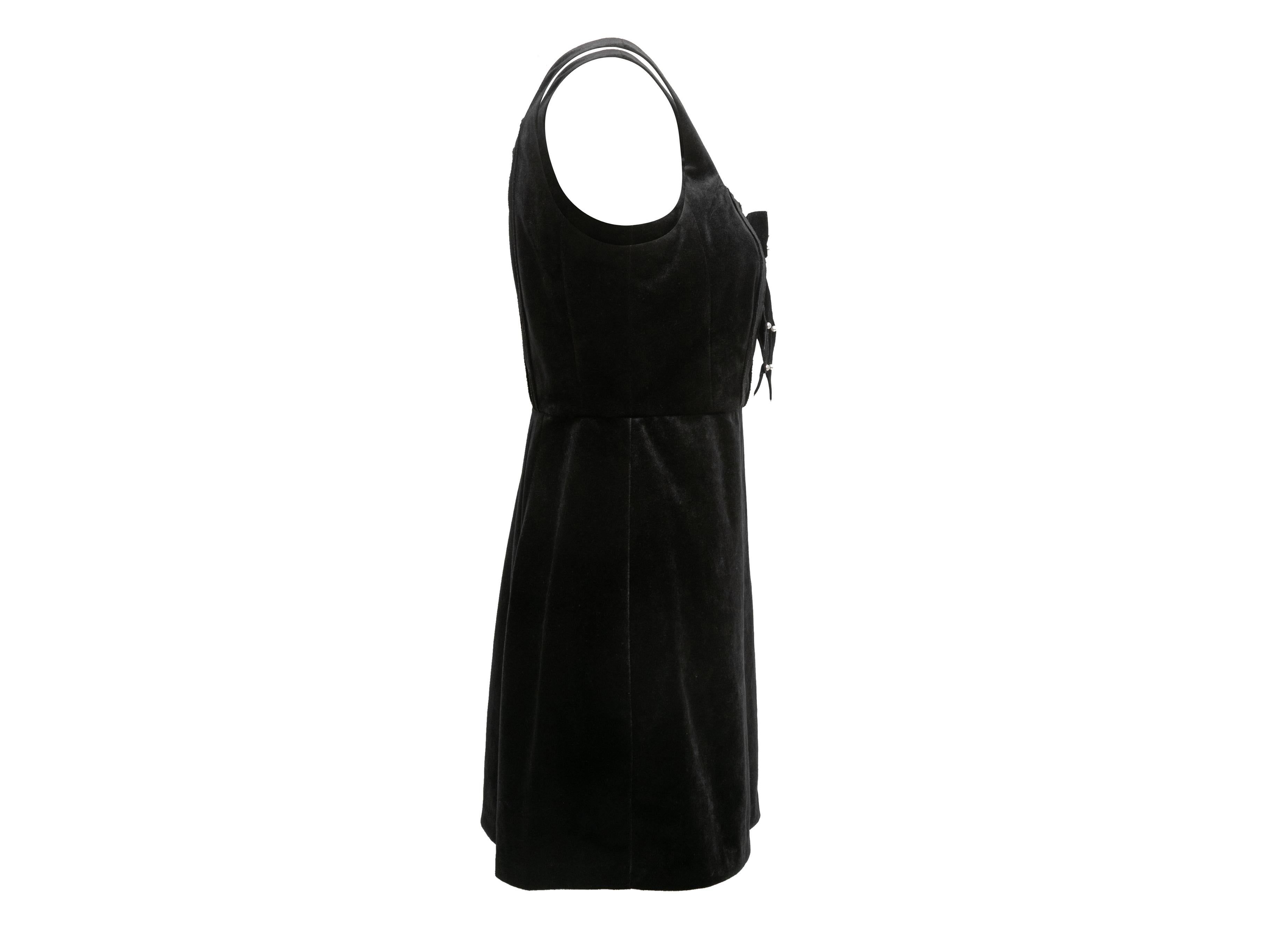 Black velvet sleeveless mini dress by LoveShackFancy. Scoop neckline. Faux pearl-embellished bow at front. Zip closure at back. 32