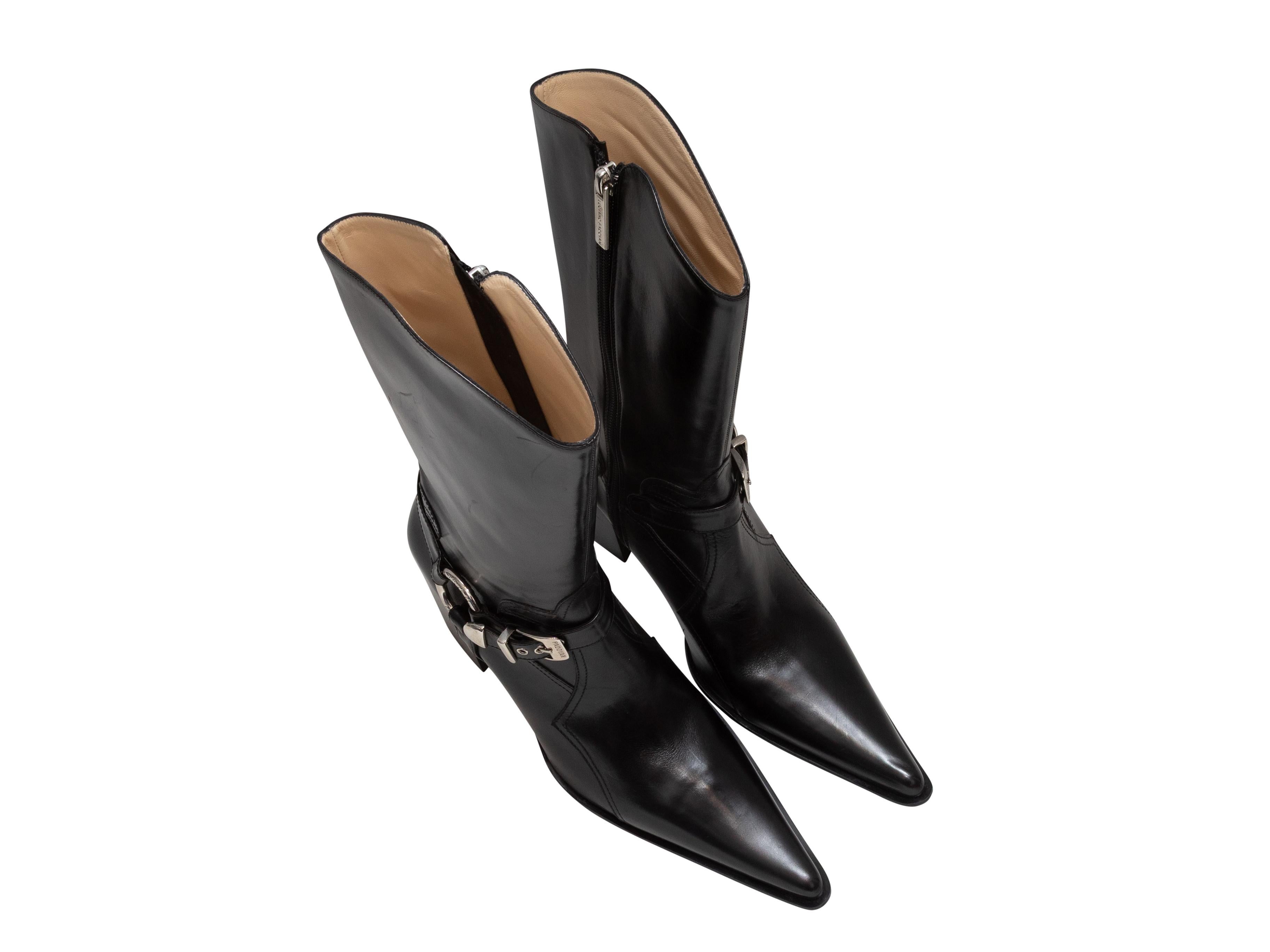 Black pointed-toe leather harness buckle boots by Luciano Padovan. Silver-tone hardware. Stacked heels. Zip closures at inner sides. 9.25