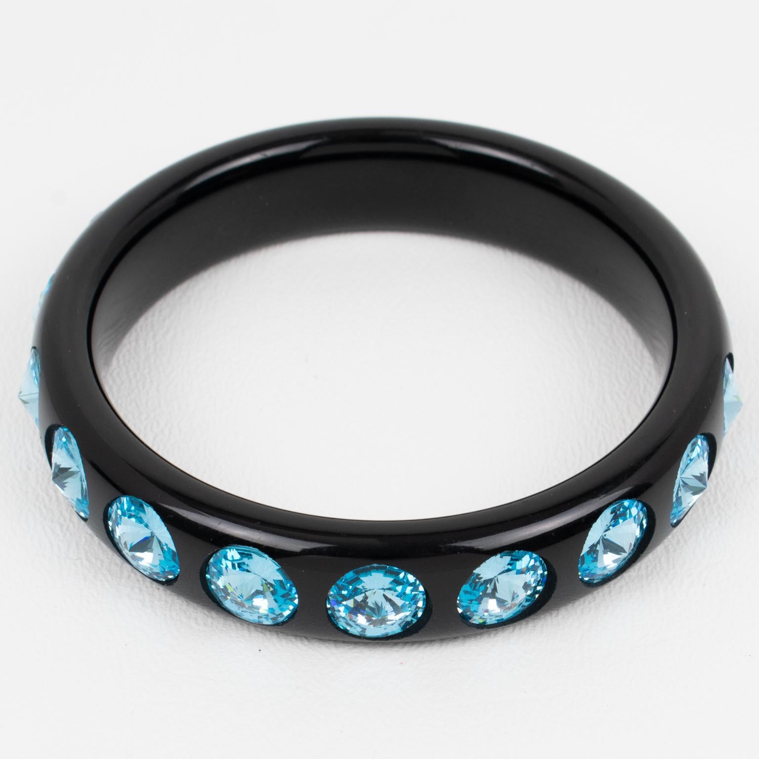 This lovely Lucite bracelet bangle features a domed shape in a true licorice black color. The bangle is ornate with massive baby blue crystal rhinestones. There is no visible maker's mark.
Measurements: Inside across is 2.57 in diameter (6.5 cm) -