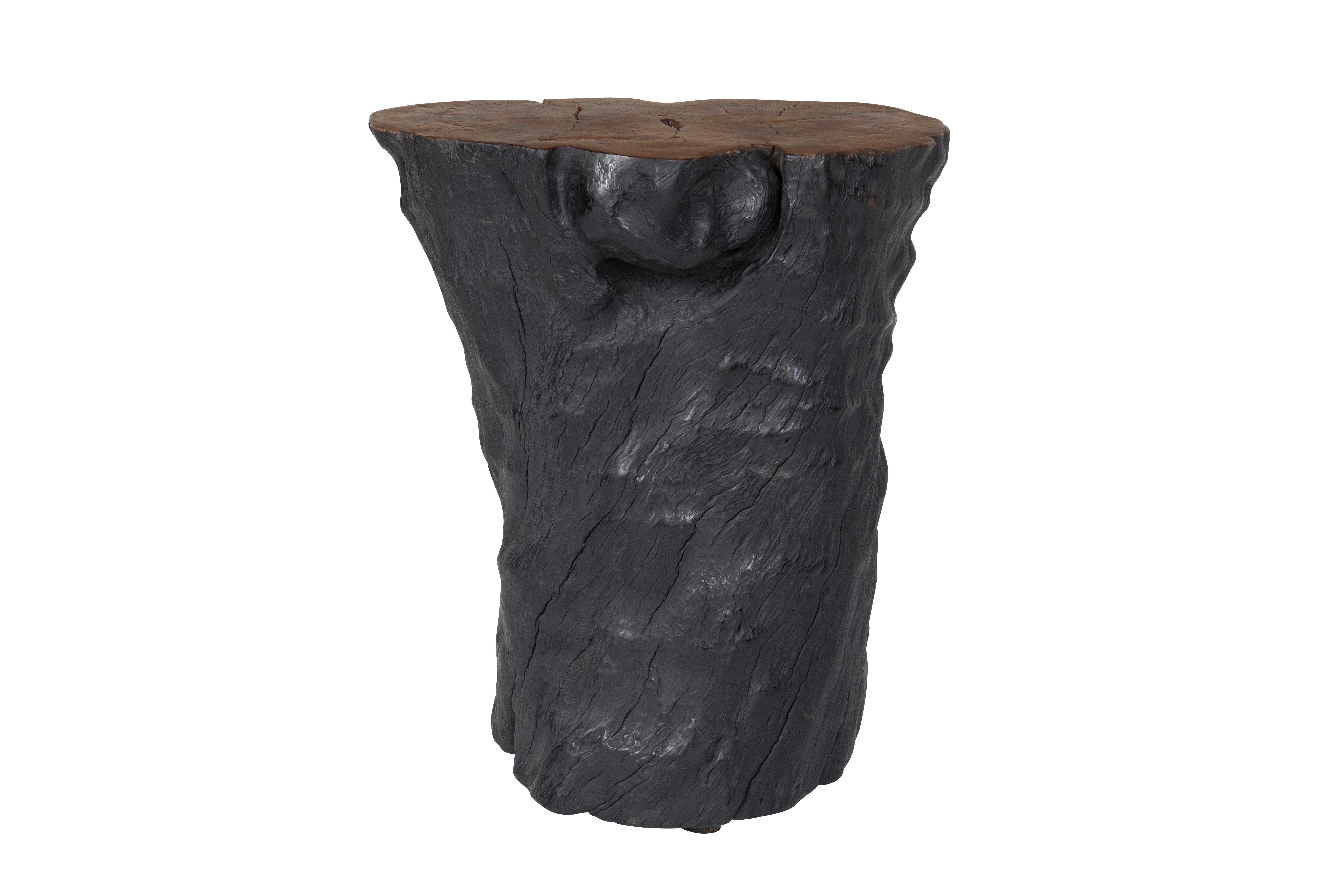 Free-formed organic-shaped lychee wood stump end table. Featuring an ebony-stained body and a warm finished accent top. This hand-carved piece has a smooth top but a natural edge respecting the beautiful grain of the hardwood it comes from.

Our