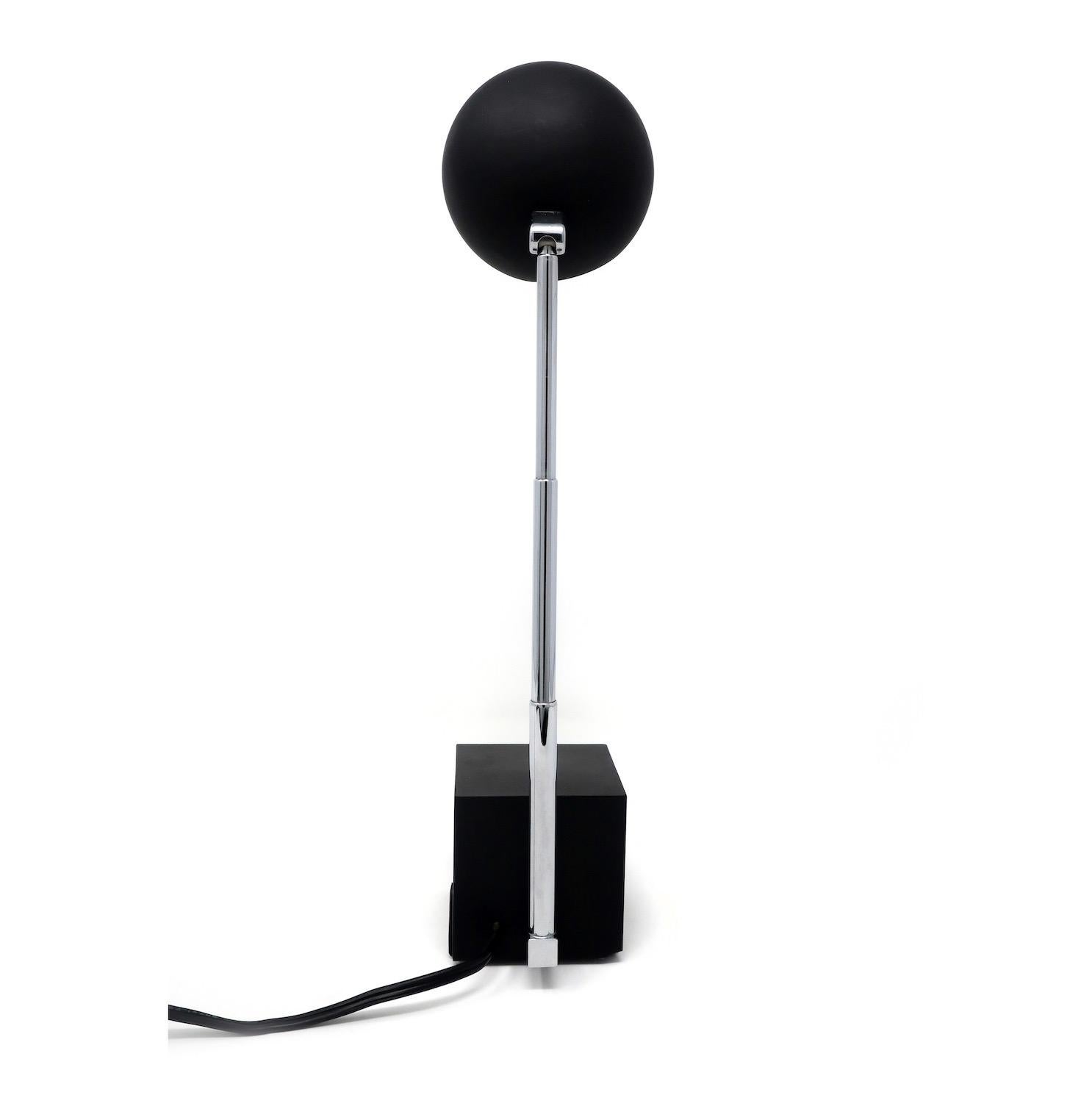 A Mid-Century Modern Lytegem desk/task lamp by Michael Lax for Lightolier (1965) with a black base and shade and extendable chrome stem, with switch for two light intensities. Can be found in the permanent collection of the Museum of Modern Art