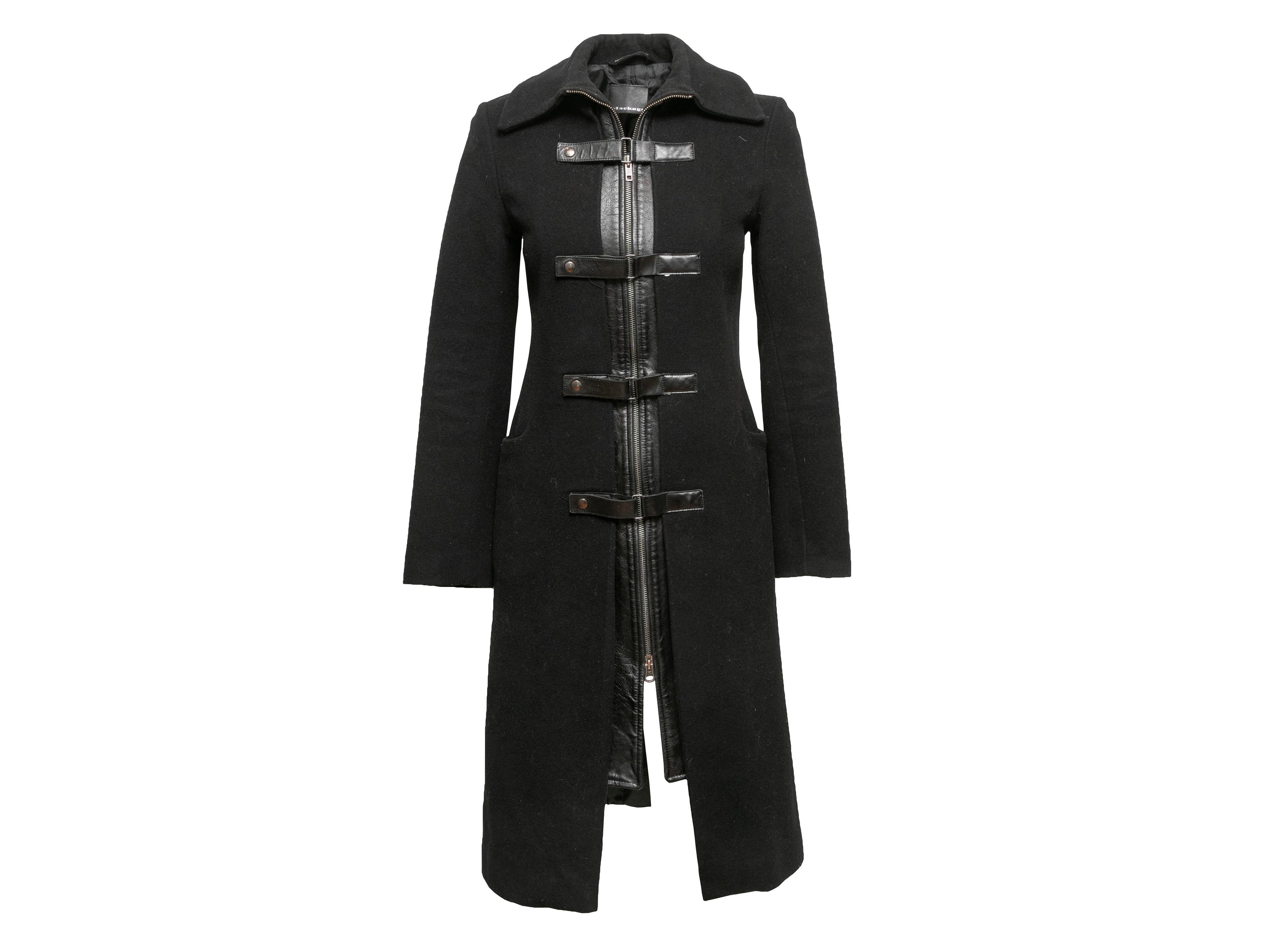 Black wool and leather-trimmed long coat by Mackage. Pointed collar. Dual hip pockets. Buckle embellishments at front. Zip closure at center front. 34