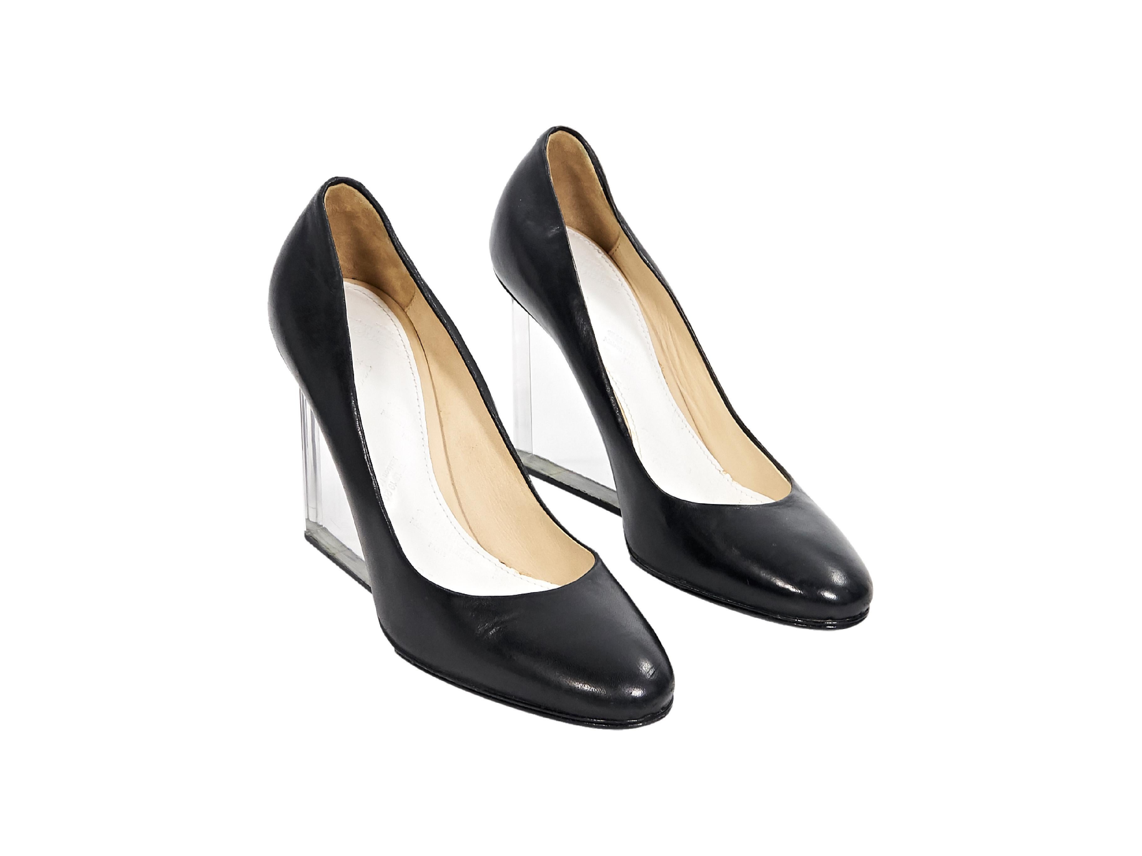 Product details:  Black leather wedges by Maison Margiela.  Round toe.  Clear lucite wedge.  Slip-on style.  3.75