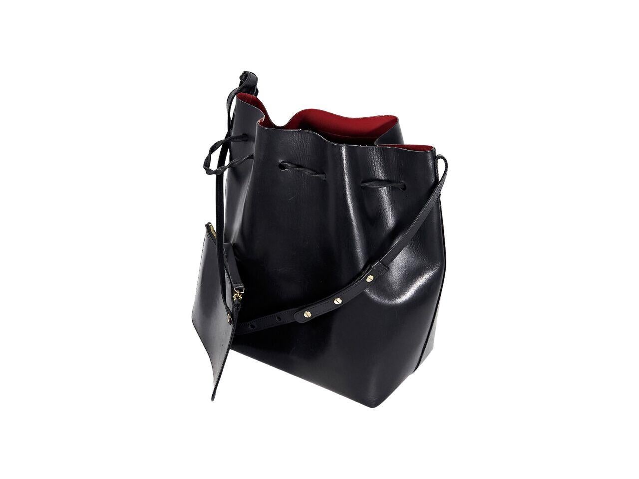 Product details:  Black leather bucket bag by Mansur Gavriel.  Adjustable shoulder strap.  Top drawstring closure.  Leather interior.  Detachable zip pouch.  Goldtone hardware.  Dust bag included.  15