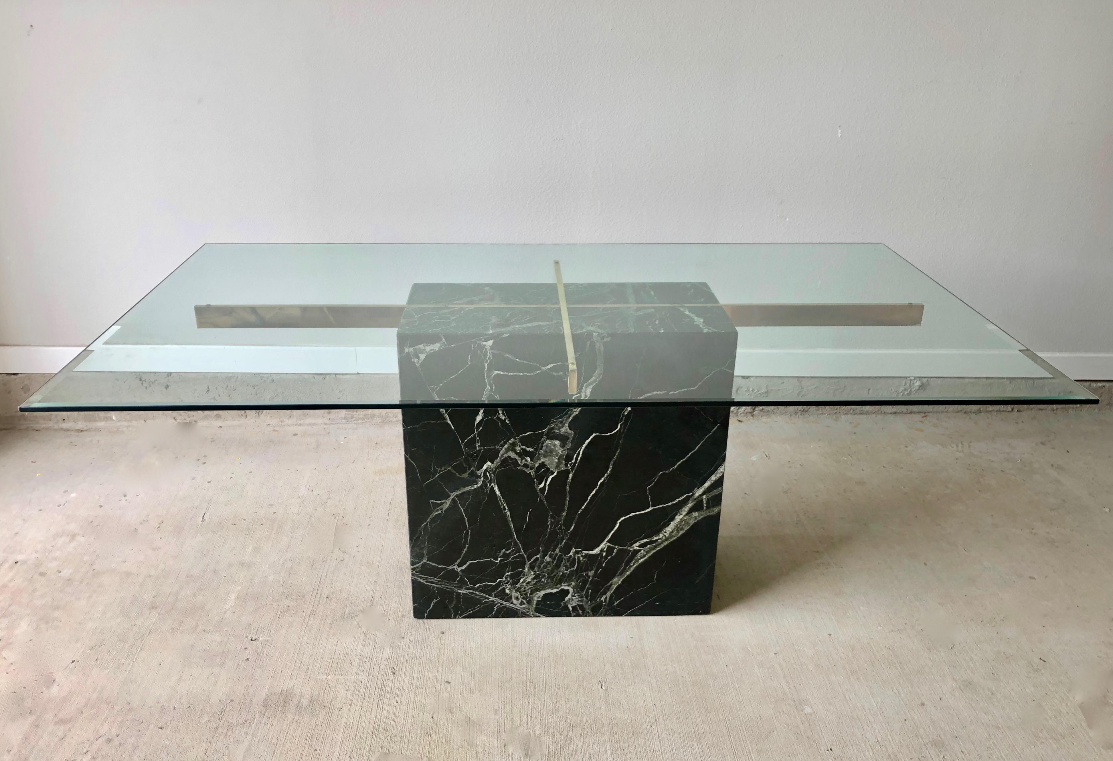 Black marble and brass base with a beveled glass top Artedi dining table.
