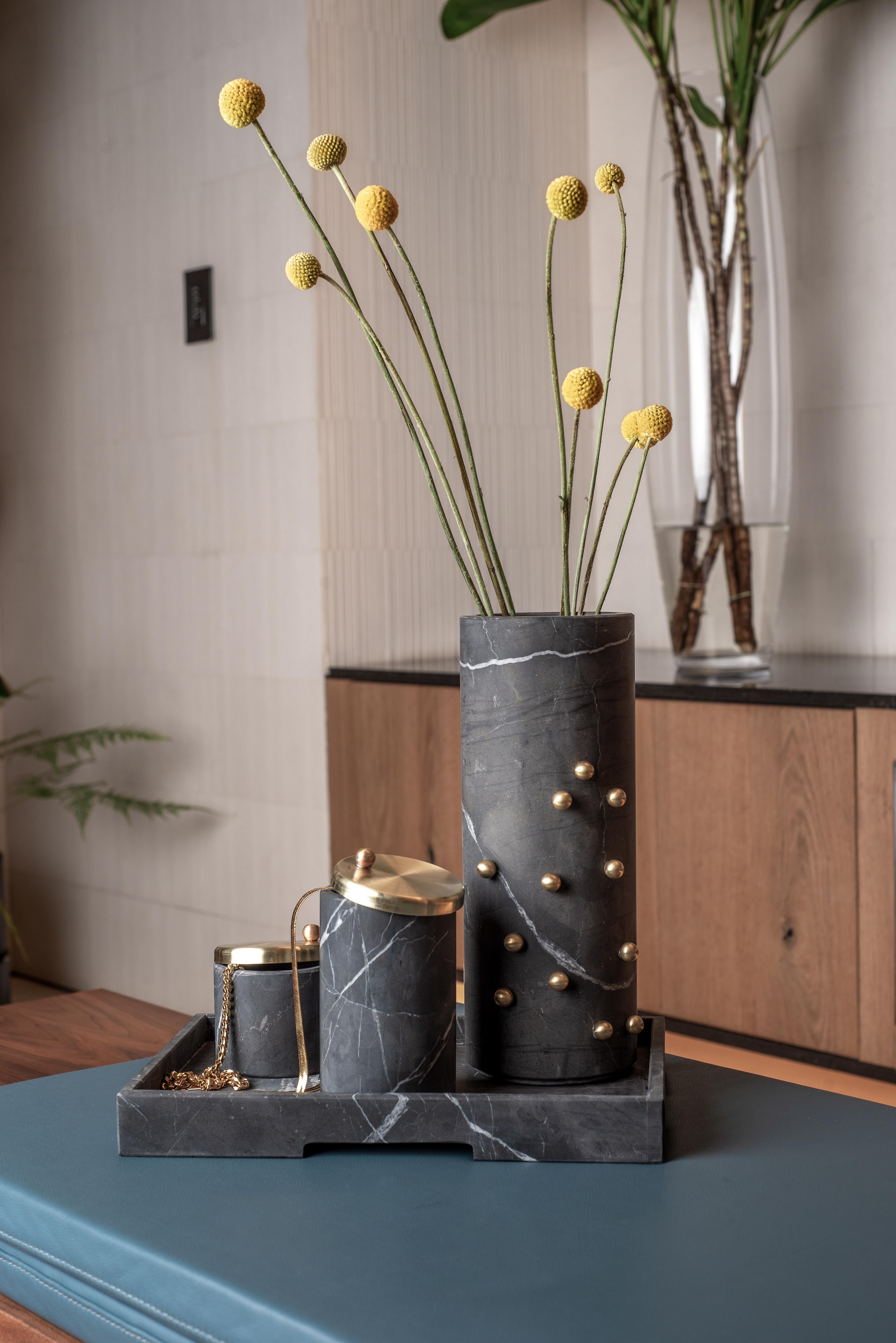 Elevate your decor with the exquisite Bruci Confetti Tall Vase, a stunning statement piece designed to add a touch of opulence to your home. Fashioned from premium quality marble, this cylindrical vase is adorned with brass sprinkles that are