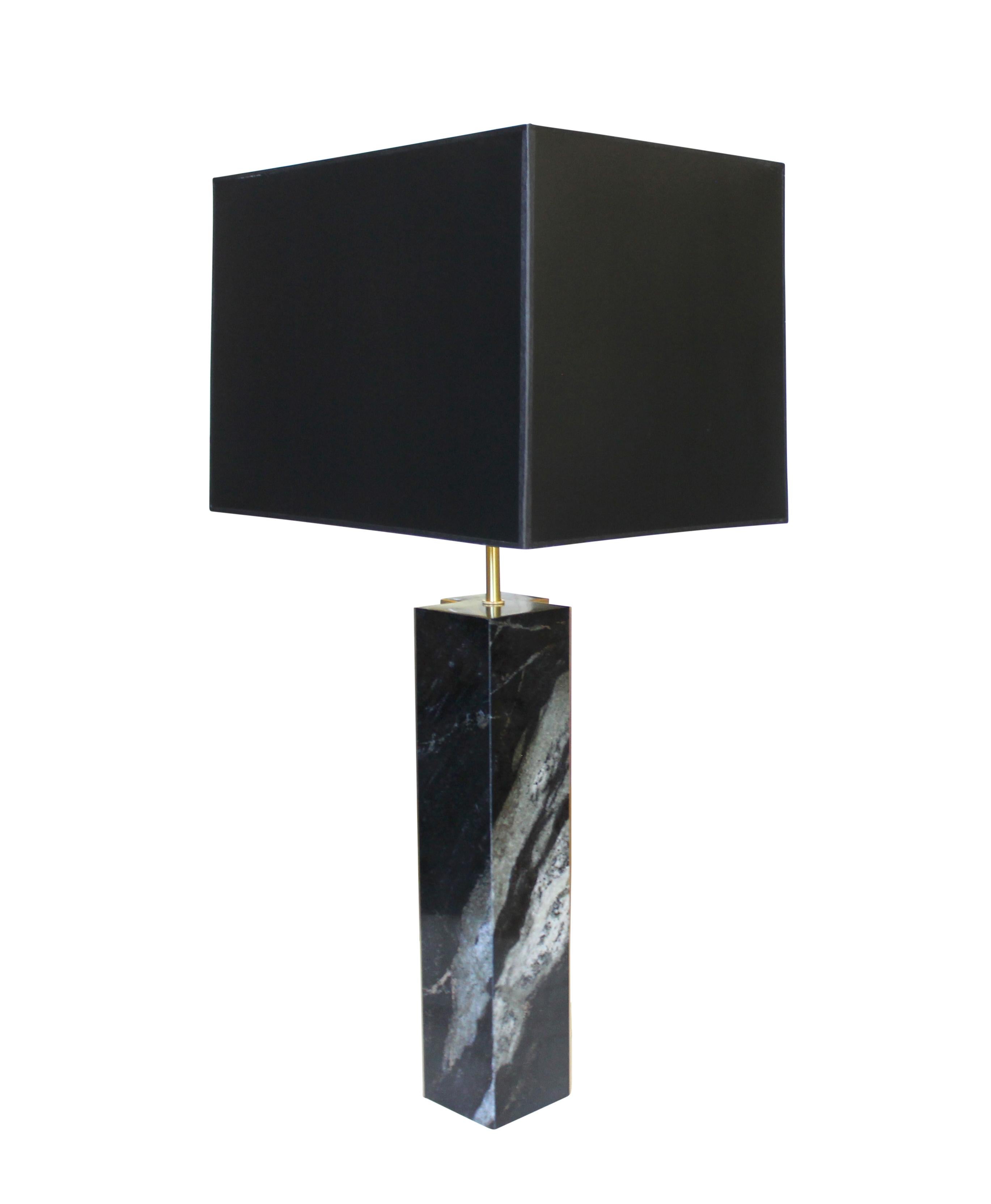 Black and white dalamata quartzite table lamp with bronze accents and black paper shade with gold interior.
Sold with or without shade.