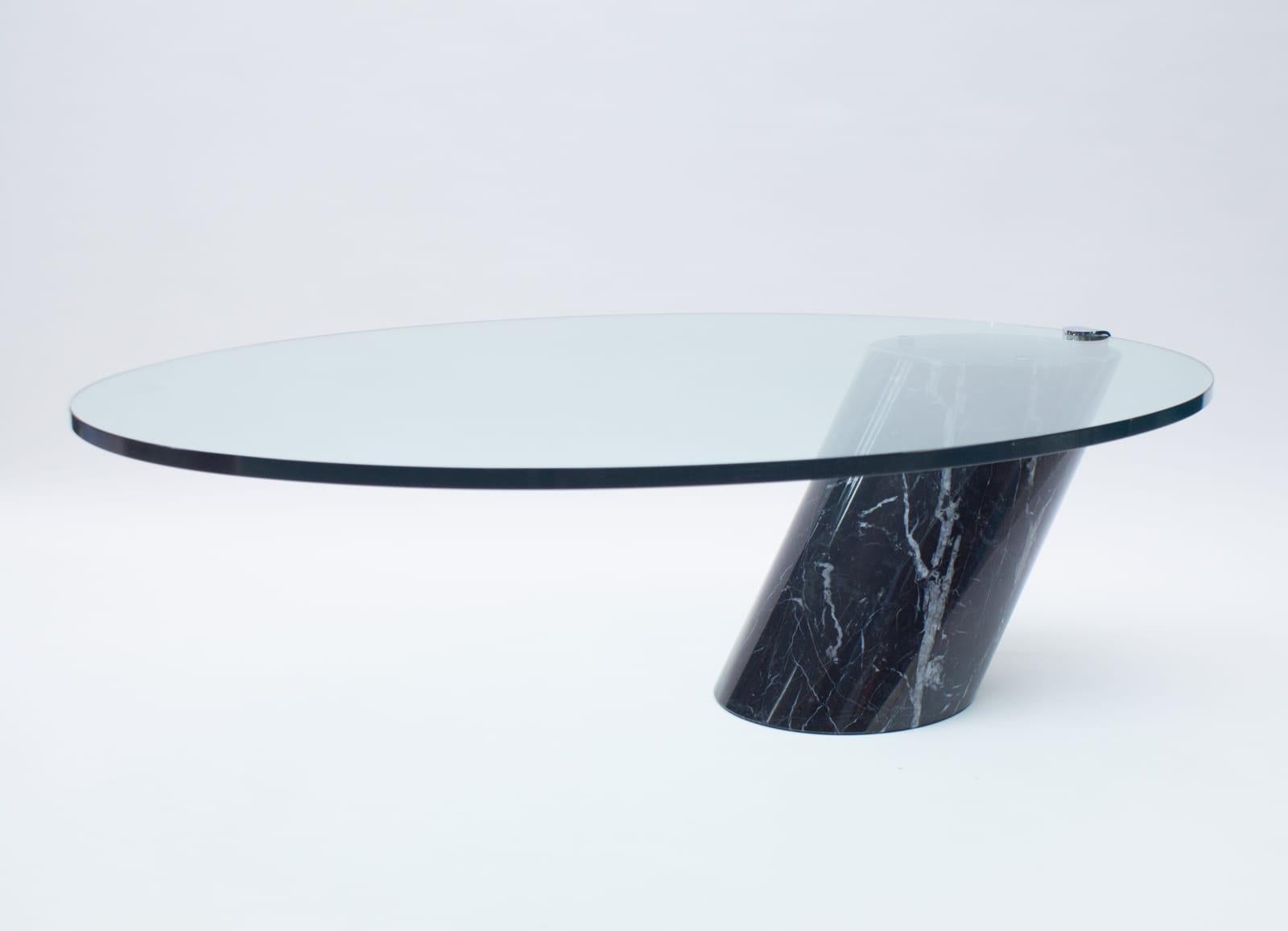 Black Italian marble with beautiful white veining.

Coffee table designed by Team Form for Ronald Schmitt in the 1970s. The base of this table is made from solid marble. 

The thick oval glass top lays loose on the marble base only held in to