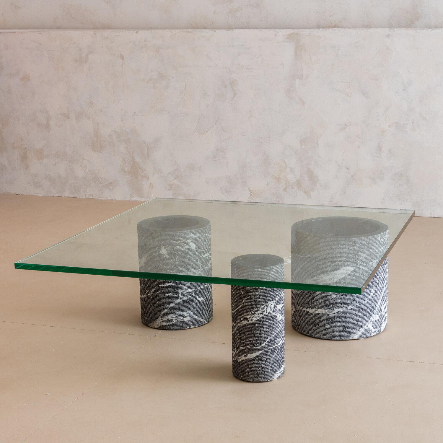 A stunning marble base coffee table formed of three honed black marble columns, in three different diameters. Designed by the celebrated Italian designer Massimo Vignelli for the Italian company, Casigiliani. Italy, 1970’s. 

