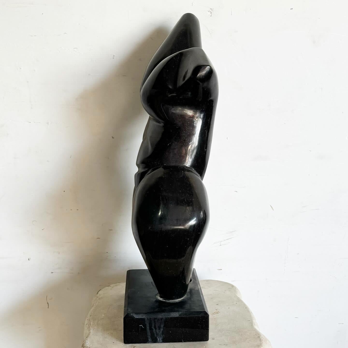 The Black Marble Botero Torso Sculpture is a sophisticated addition to any art collection. Inspired by Fernando Botero's distinctive style, it features a voluptuous and stylized human torso, expertly carved from sleek black marble. Mounted on a